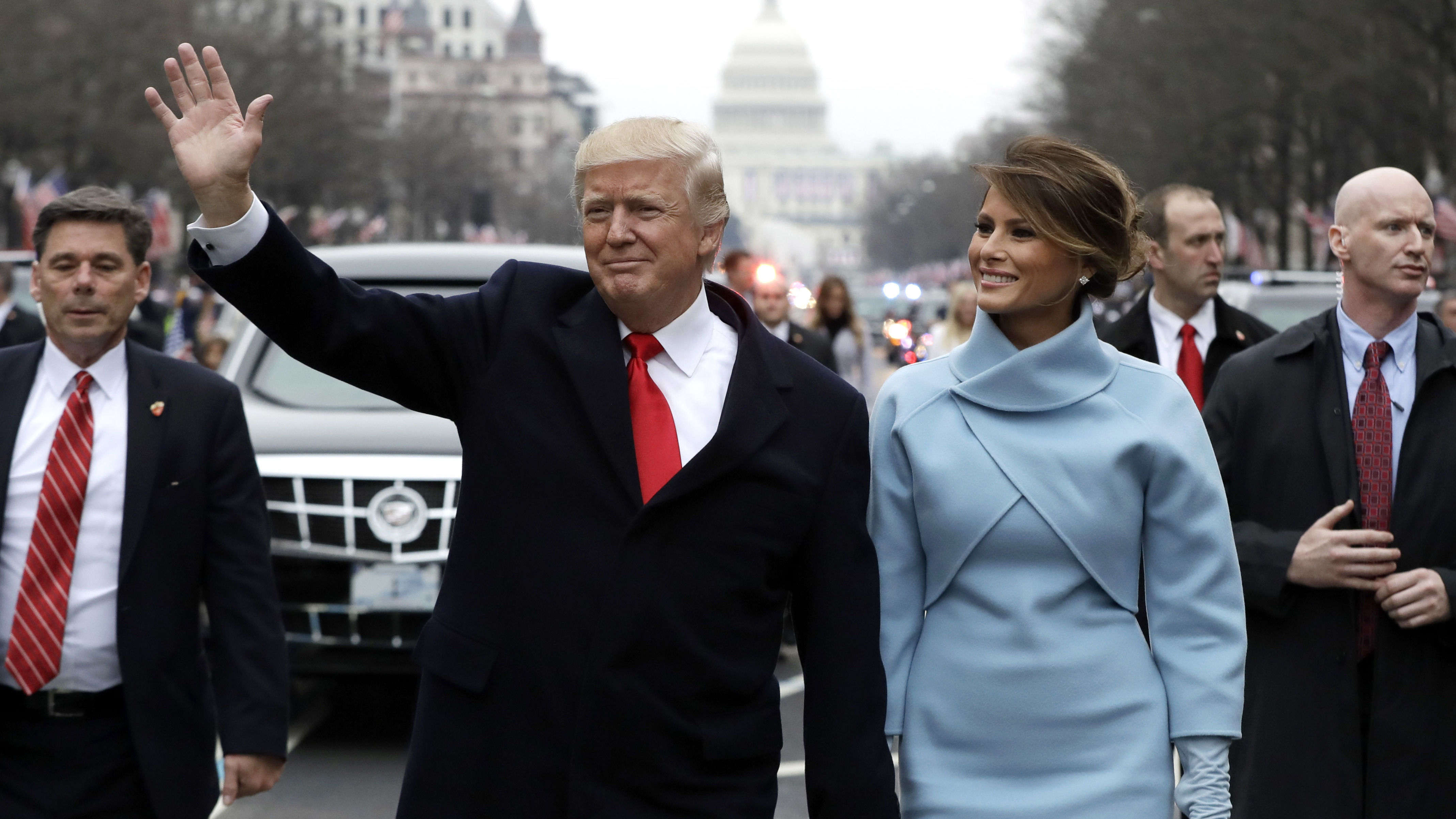 President Trump waves to supporters as he walks the parade route with first lady Melania Trump after being sworn in on Jan. 20. (Getty Images)