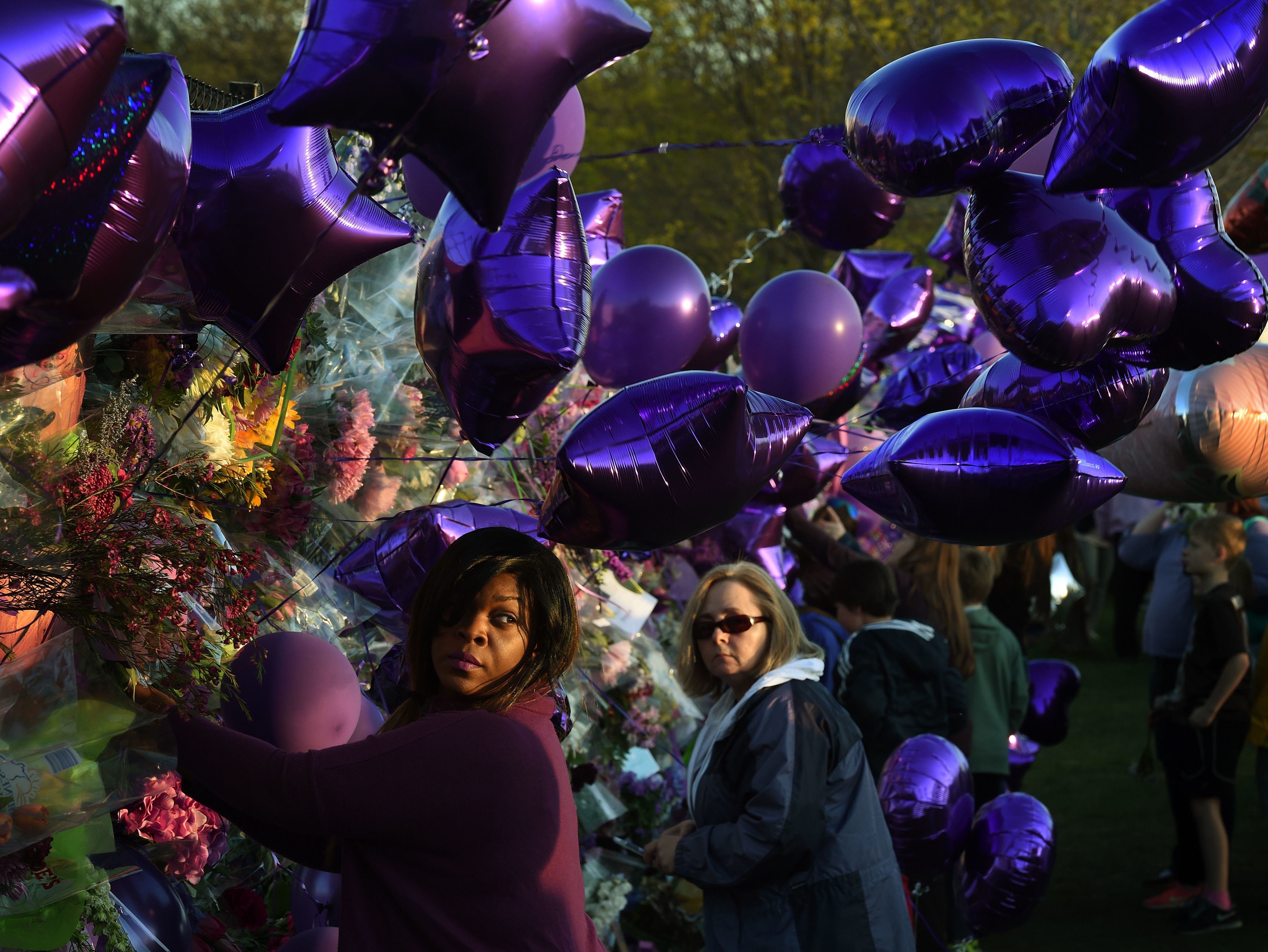 In The Wake Of Prince's Death 6 Prince fans pay their respects at a memorial wall outside the Paisley Park compound of music legend Prince in Minneapolis, Minn., on April 22, 2016.