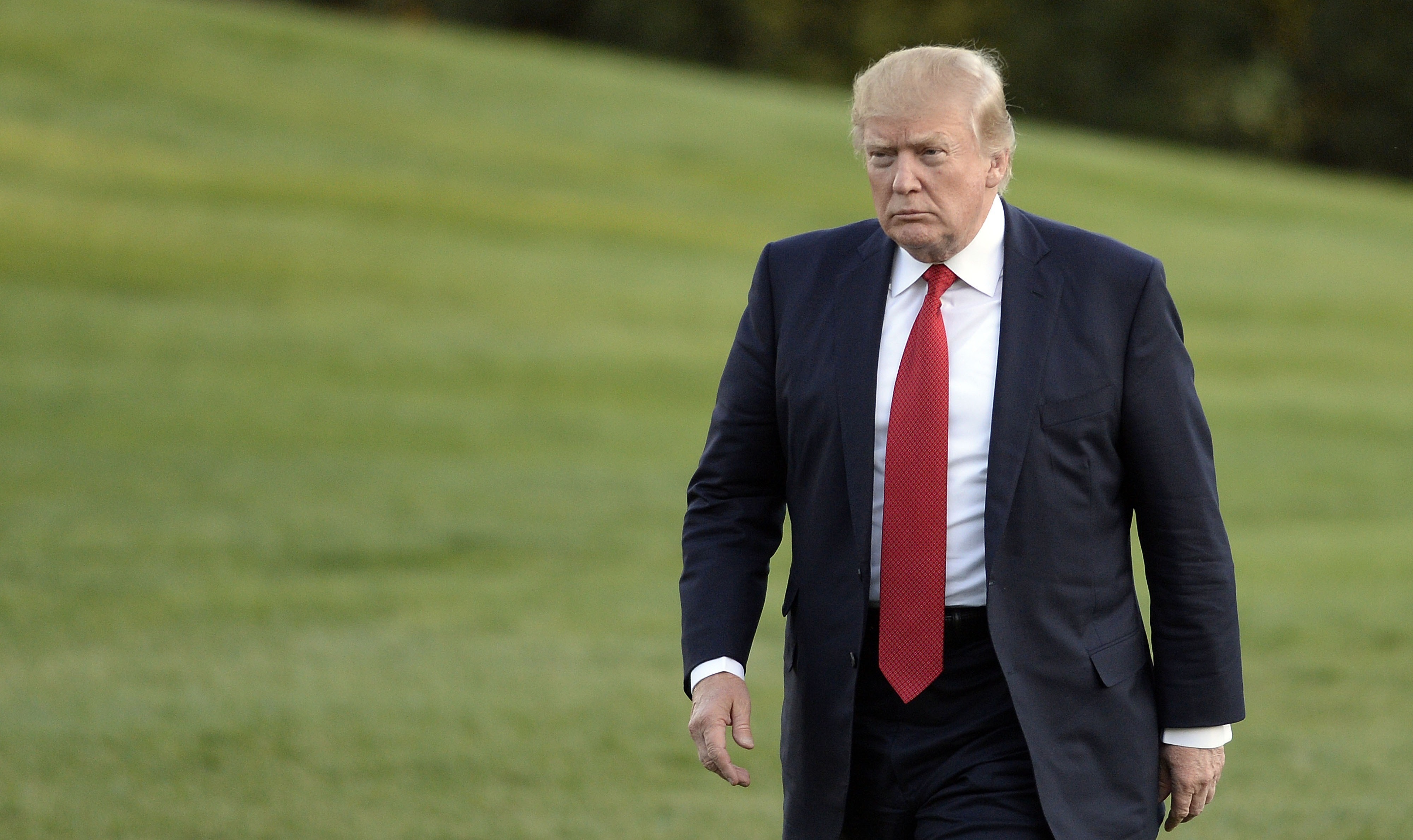 President Trump walks on the South Lawn after returning to the White House earlier this month. A government shutdown is just three days away, and Trump is digging in on demands. (Getty Images)