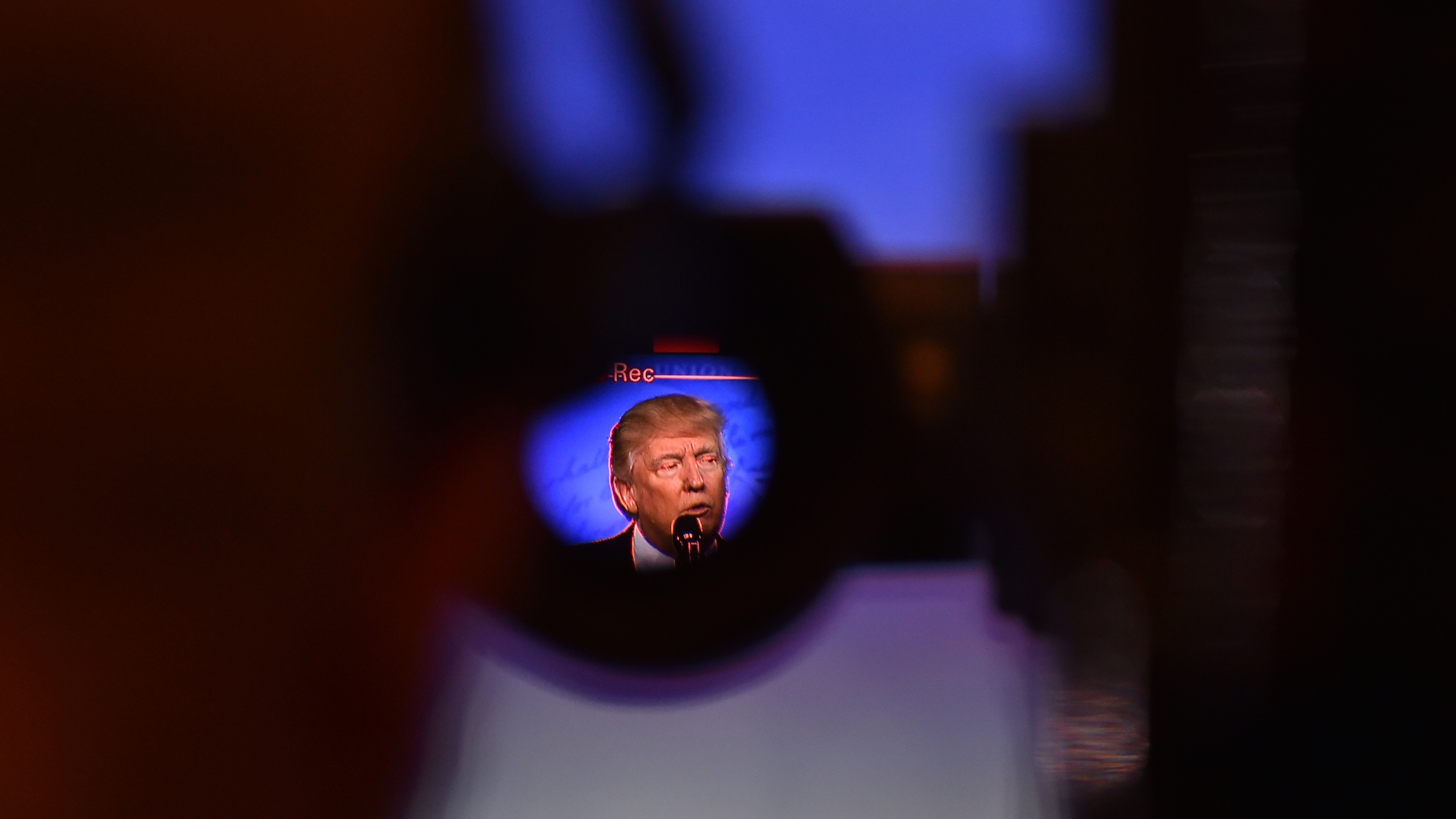 Through a video camera viewfinder, President Trump is seen addressing the crowd during the Conservative Political Action Conference in February. (The Washington Post via Getty Images)