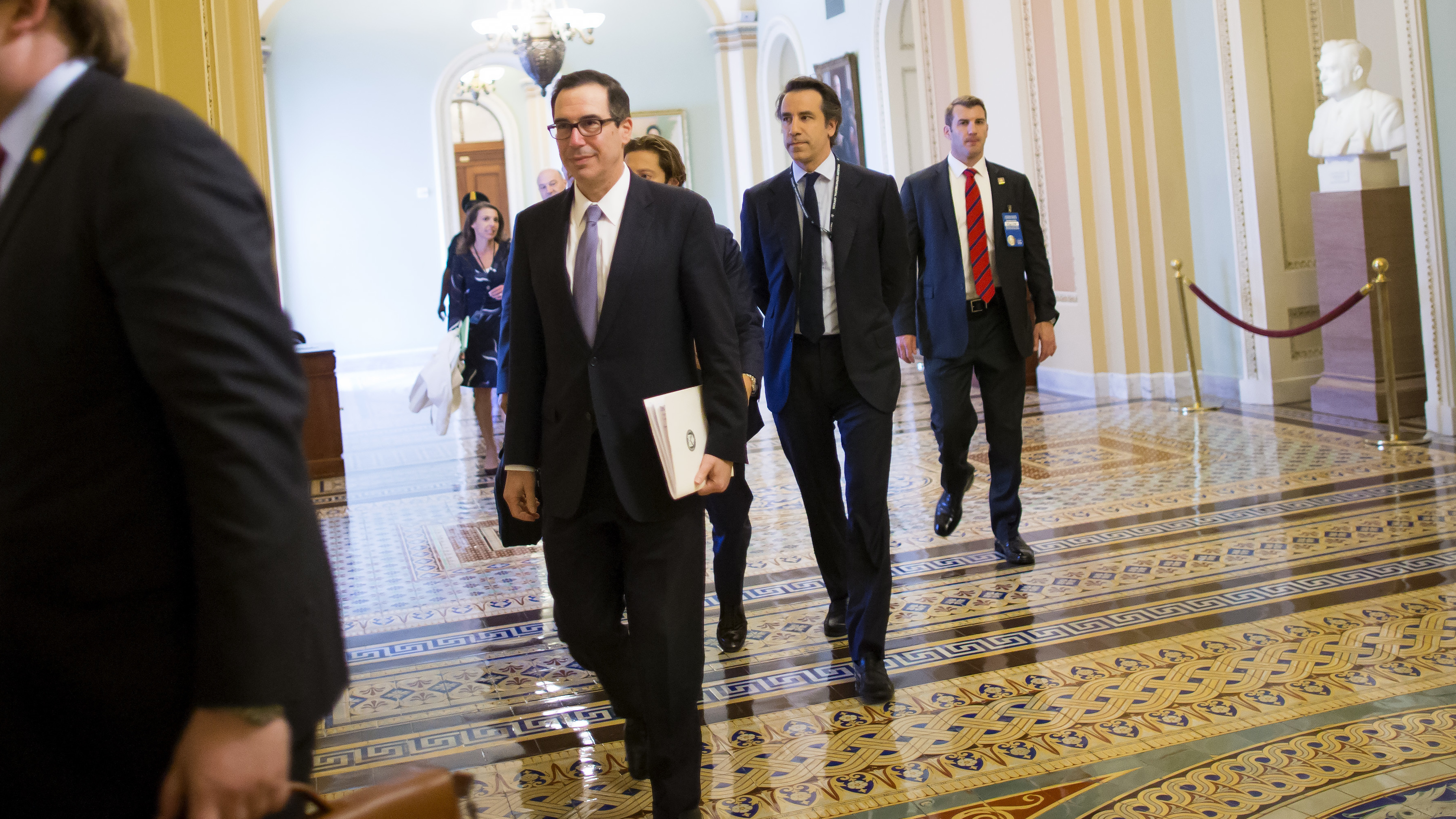 Treasury Secretary Steve Mnuchin (center) arrives Tuesday at a meeting with congressional leaders to discuss a tax overhaul. (Getty Images)