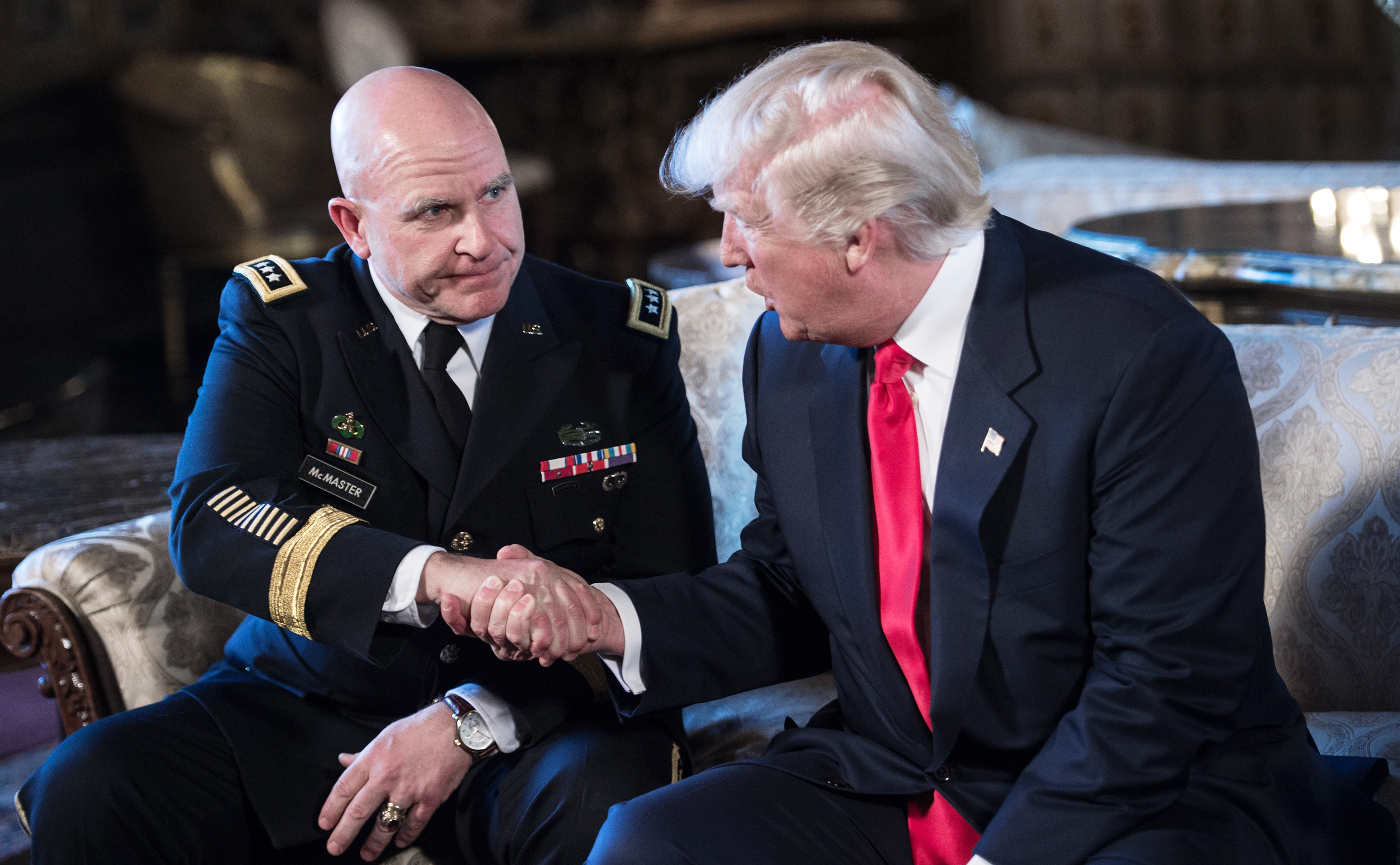 President Donald Trump shakes hands with Army Lt. Gen. H.R. McMaster, his national security adviser, at Trump's Mar-a-Lago resort in Palm Beach, Florida, in February. (AFP/Getty Images)