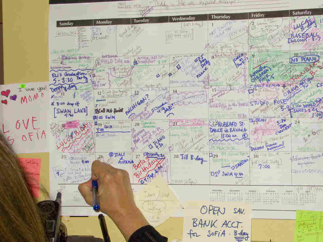 Woman writing on full calendar