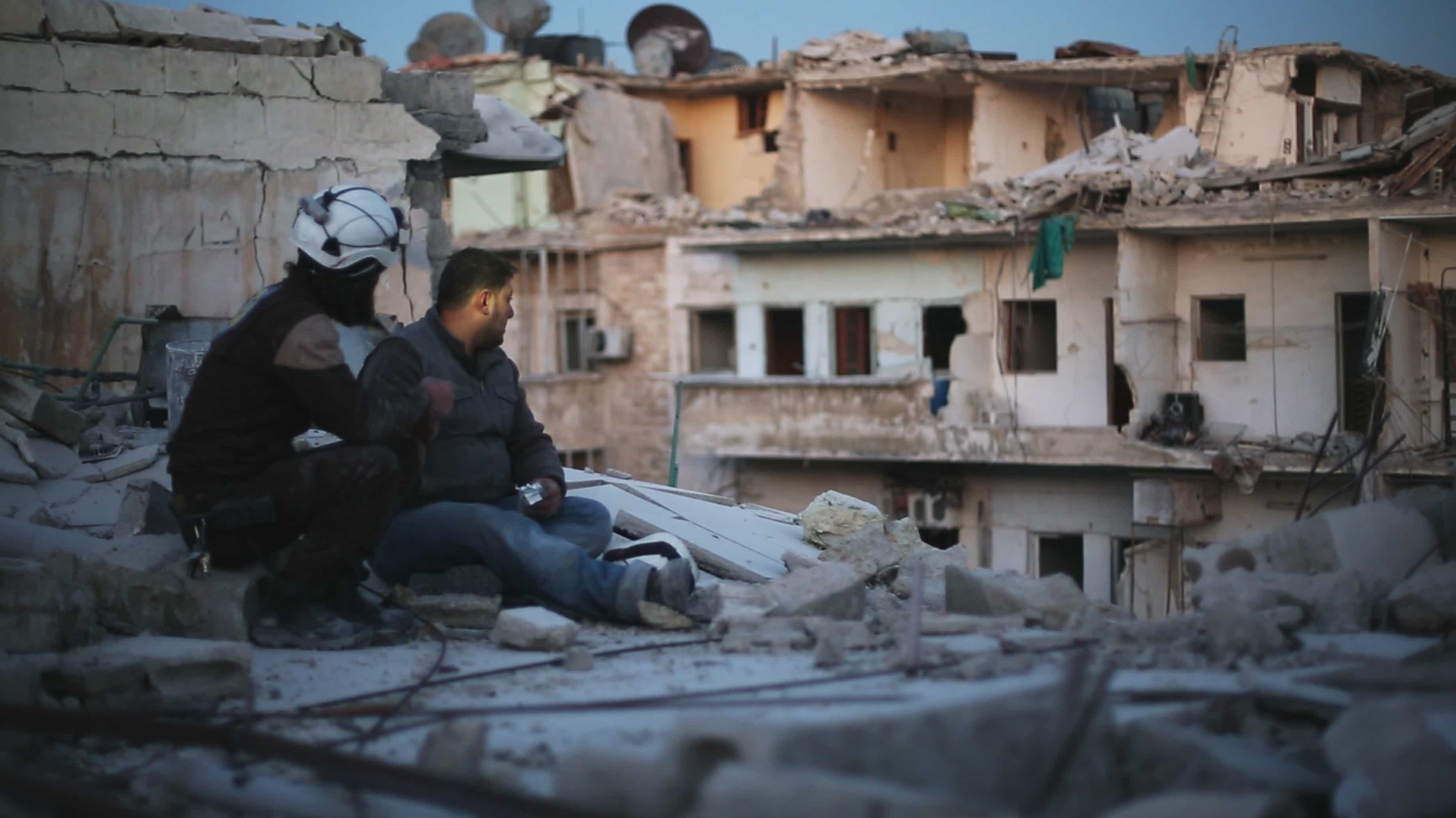 Two members of &quot;The White Helmets&quot; pause to take stock in the documentary <em>Last Men in Aleppo.</em> (Grasshopper Films)