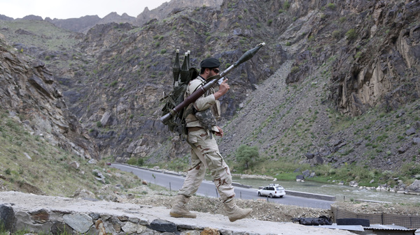 An Afghan soldier walks at a checkpoint last month on the outskirts of Kabul, Afghanistan.