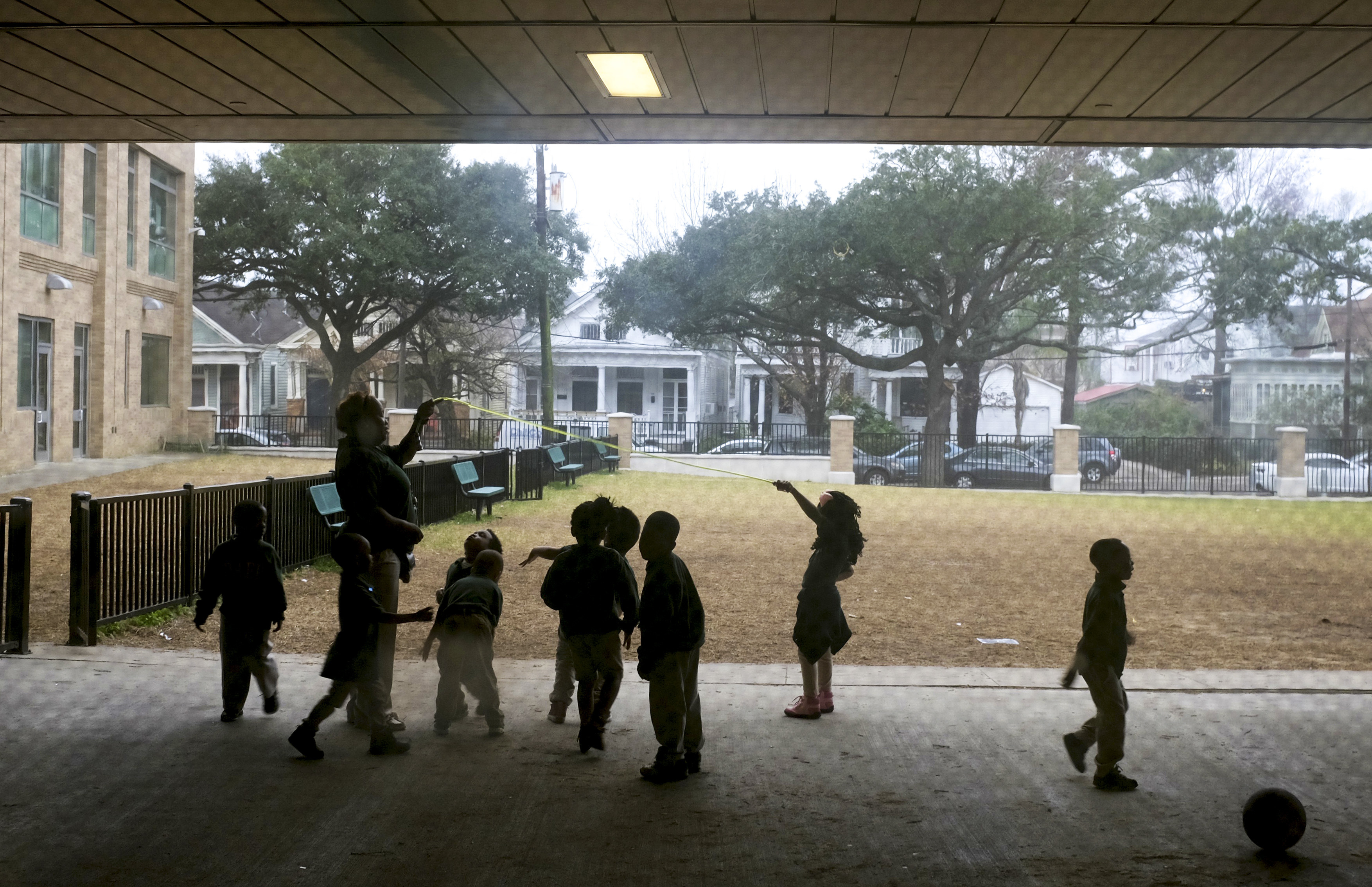 Young children play outside in the fog at Crocker College Prep, an elementary school in New Orleans. (WWNO)