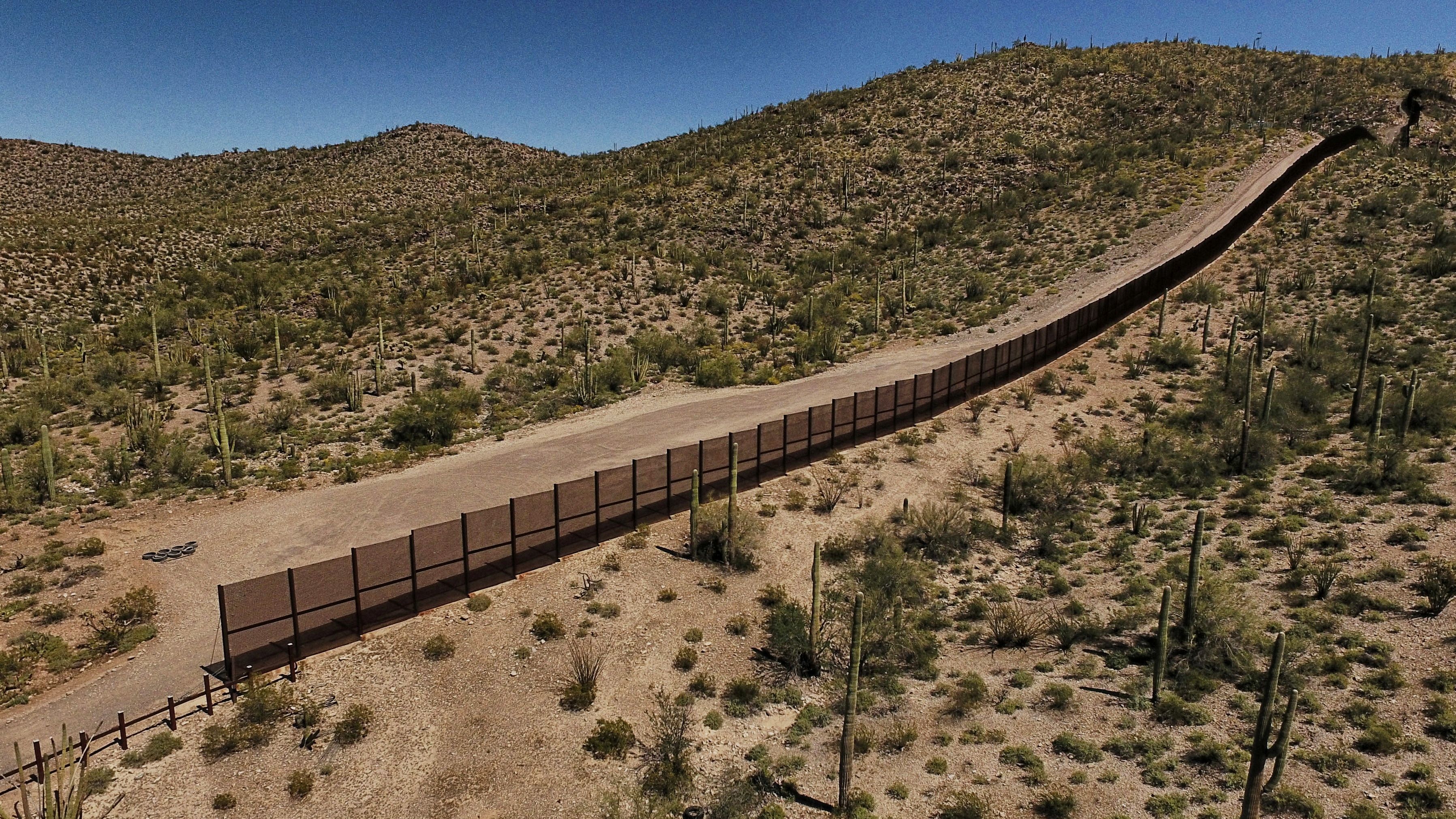 The metal fence along the border between Sonoyta, Mexico, and the Arizona desert in the United States.