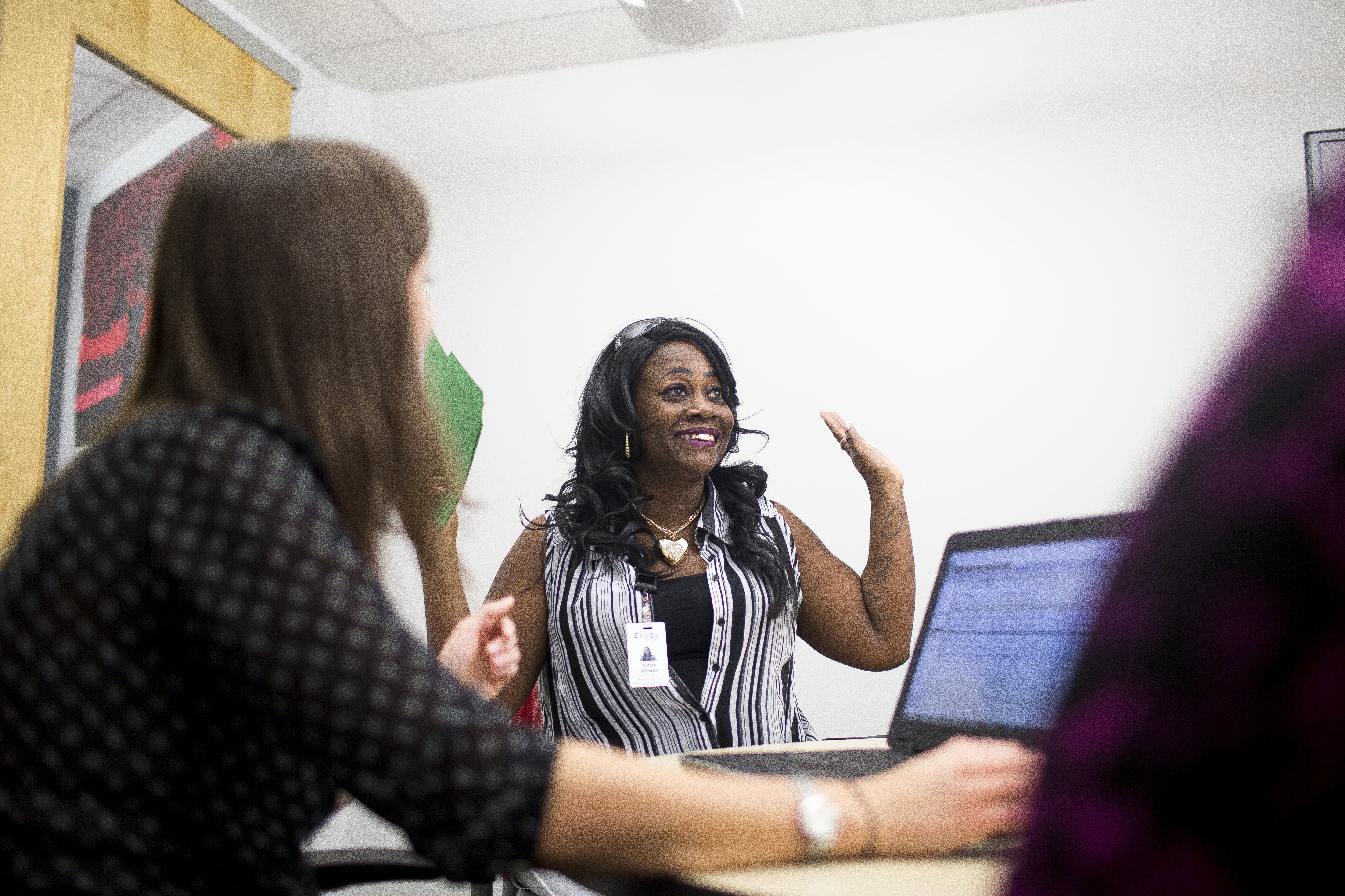 Katina Johnson celebrates during a meeting with her Goodwill Central Texas guidance staff to discuss higher education options. (KUT)