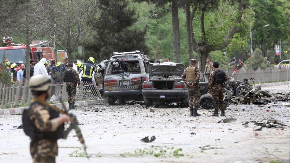 Security forces inspect the site of a suicide attack in Kabul, Afghanistan. A deputy spokesman for the Interior Ministry said the target of the blast was a convoy of foreign forces. (Massoud Hossaini/AP)