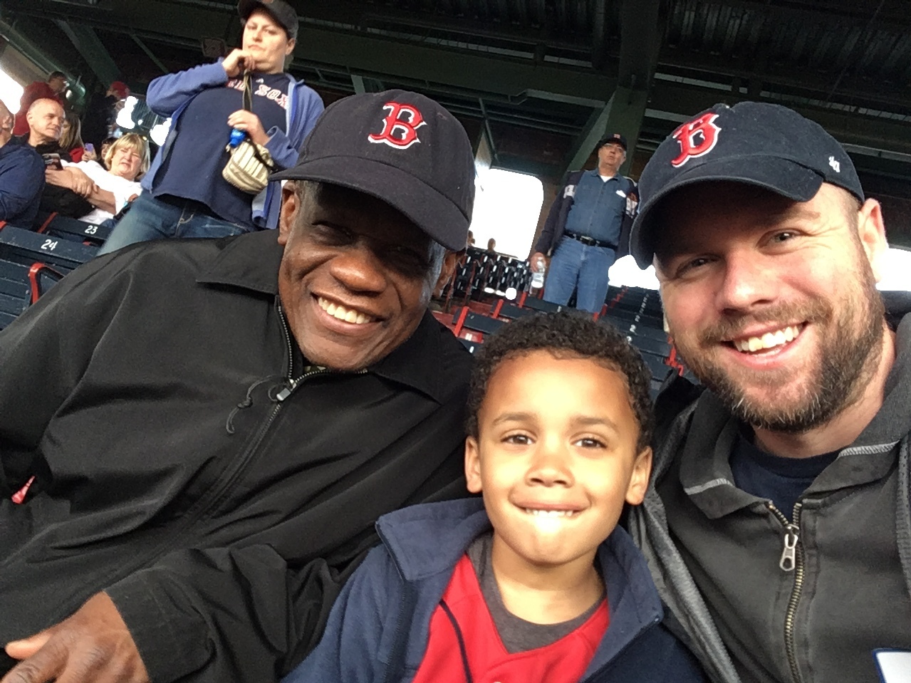 Calvin Hennick (right) attends a Red Sox game with his son, Nile, and his father-in-law, Guy Mont-Louis, at Boston's Fenway Park. Hennick reported a white fan who he said made a racist remark about a Kenyan woman who sang the national anthem. (Courtesy of Calvin Hennick)