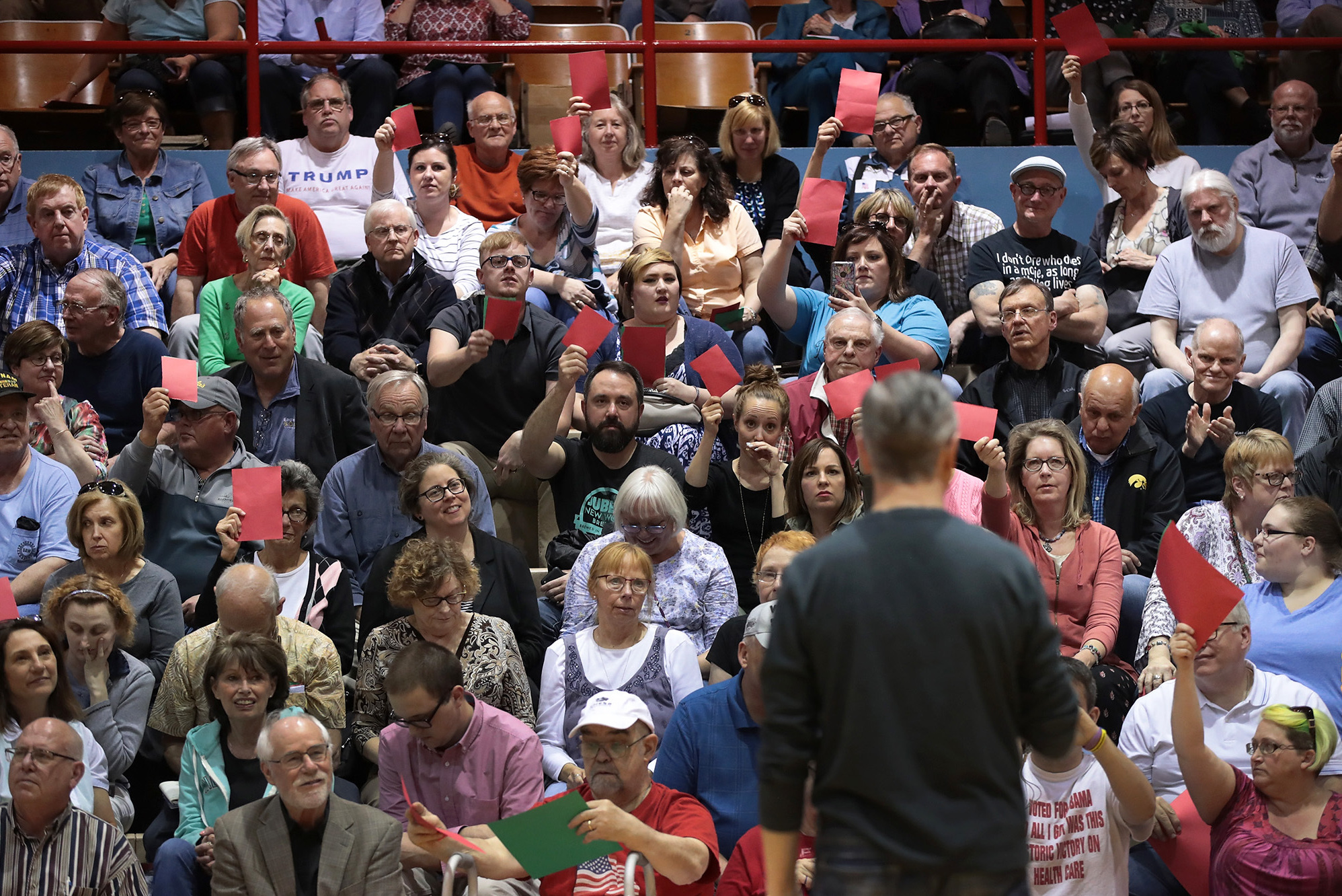 People attending Rep. Rod Blum's town hall event in Dubuque, Iowa, this week held up red sheets of paper to show disagreement with what the Republican congressman was saying and green to show they concurred. The GOP health care bill was a major concern of many. (Getty Images)