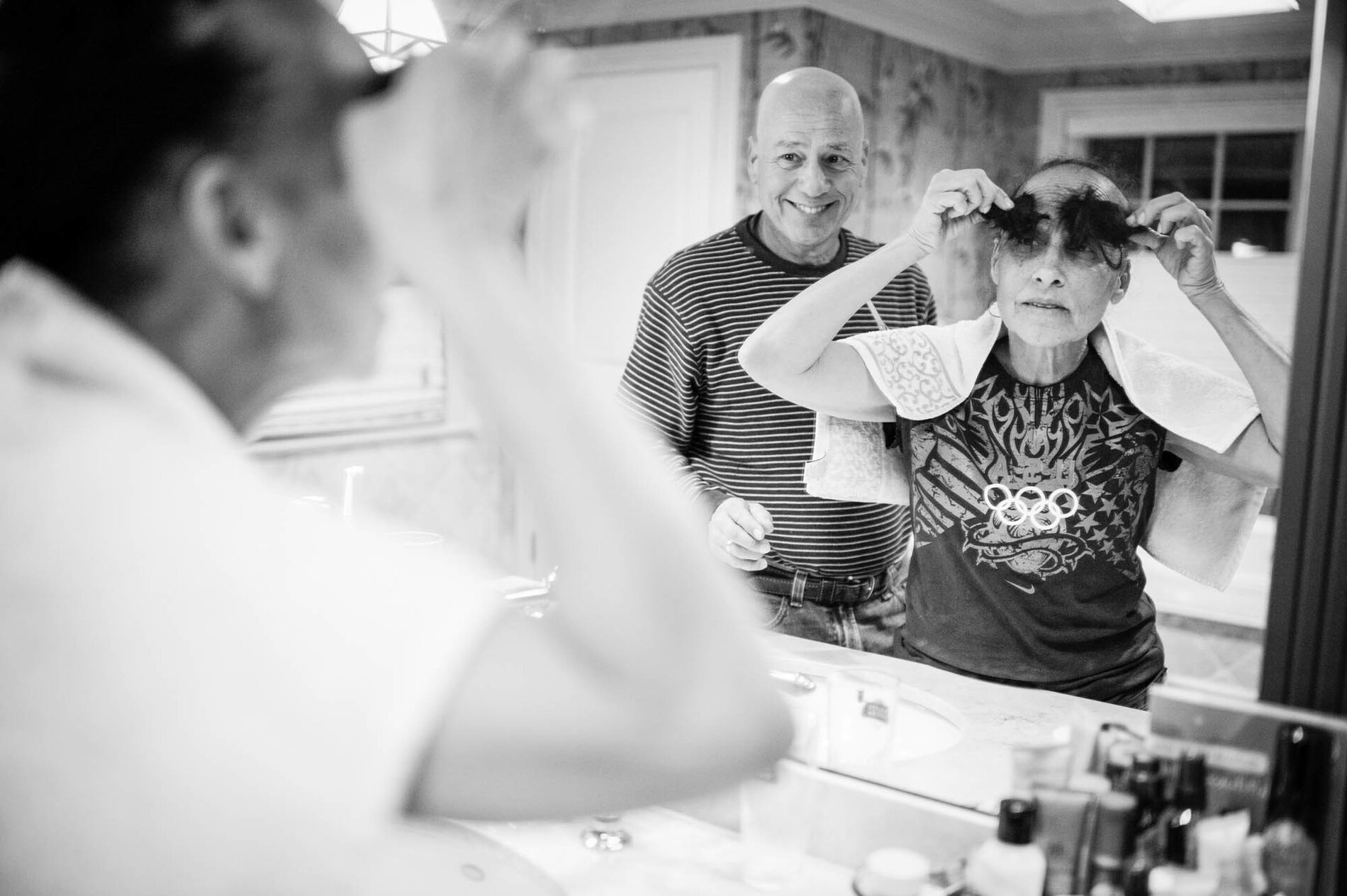 Late one evening, Dad cut Mom's hair, knowing that it would start falling out on its own in the coming weeks as a side effect from the chemotherapy. Mom turned the shorn locks into eyebrows.
(Nancy Borowick)