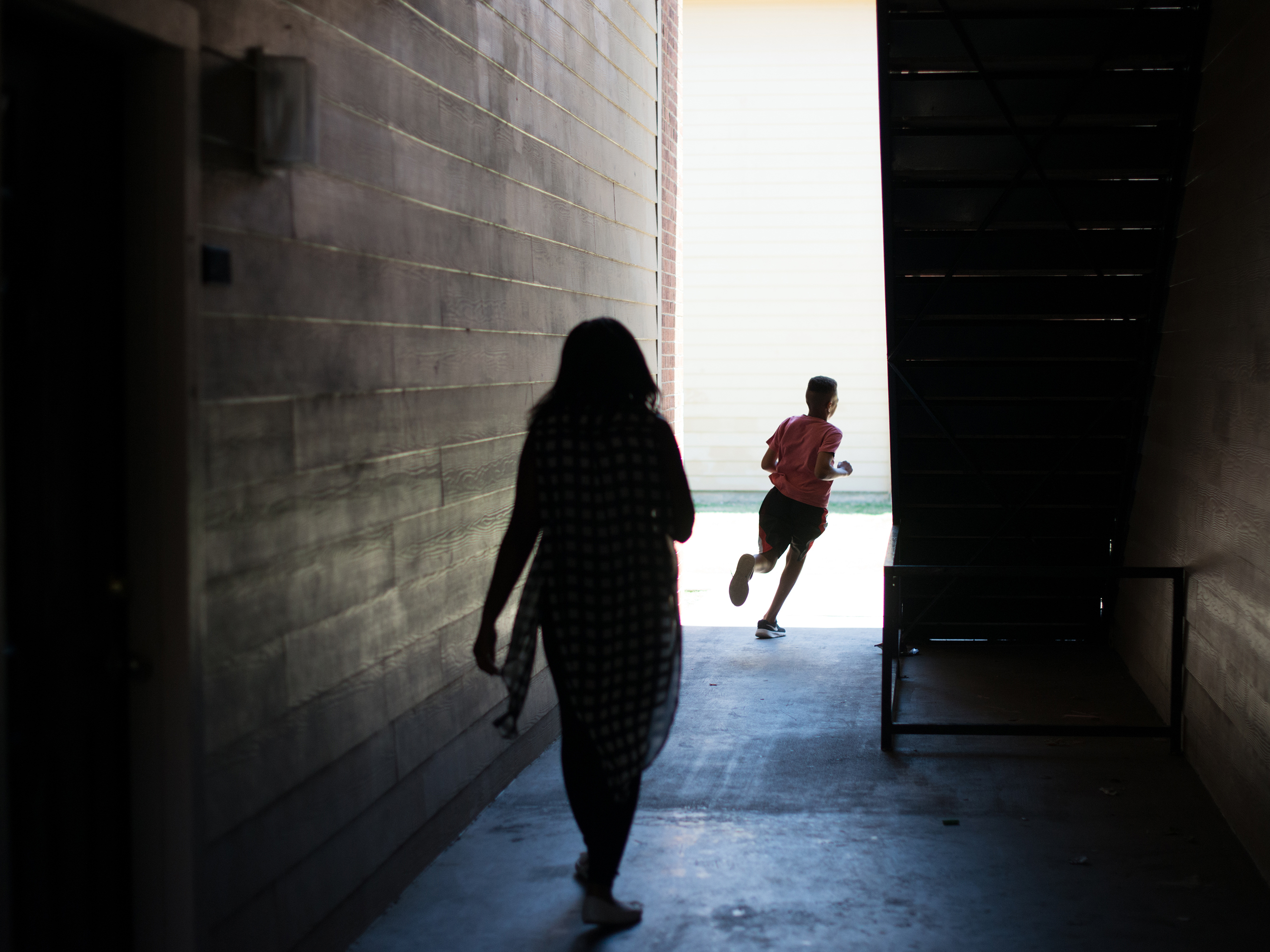 C'Artis Harris' children run off to the playground. Without finding housing to use her Section 8 housing, Harris and her children continue to live with a friend. (Brandon Thibodeaux for NPR)