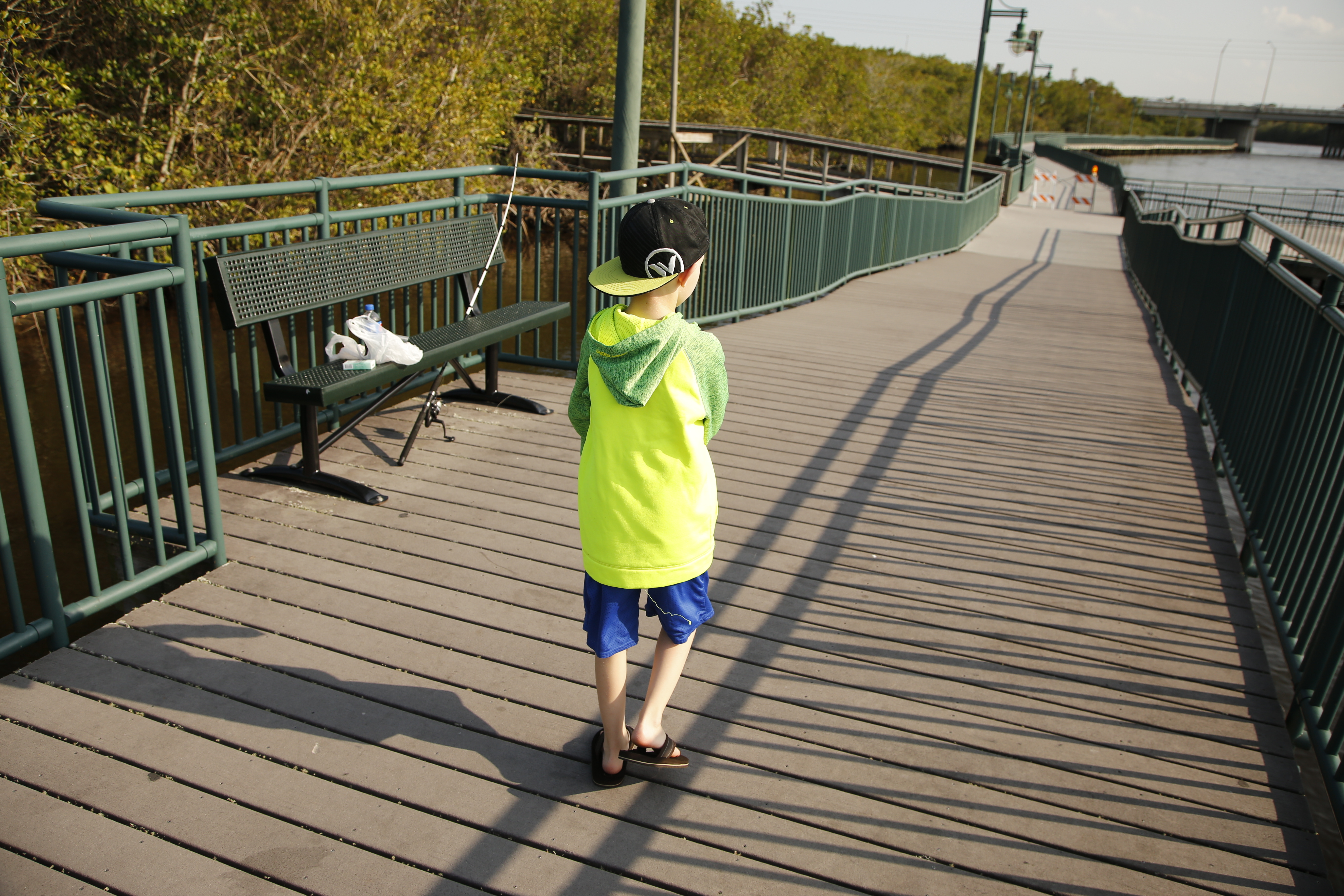 Ayden, 9, walks along a boardwalk at River Park Marina in Port St. Lucie, Fla. He has autism, ADHD and a seizure disorder, which many schools in the area are not equipped to help him with. (Zak Bennett for NPR)
