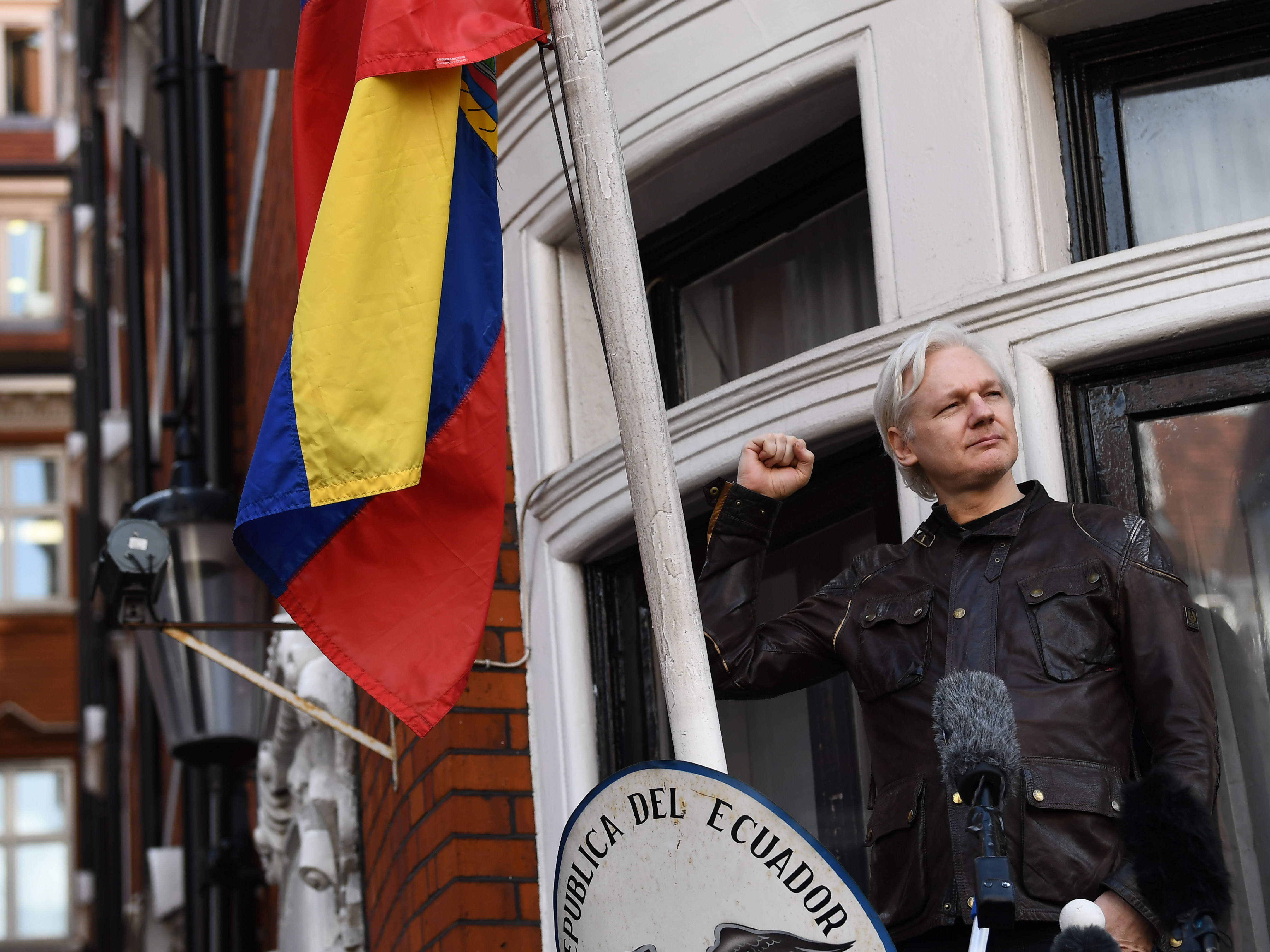 WikiLeaks founder Julian Assange raises his fist before addressing reporters from the balcony of the Ecuadorian Embassy in London on Friday. In his speech, Assange said there are still plenty of legal battles still to wage: &quot;The proper war is just commencing.&quot; (AFP/Getty Images)