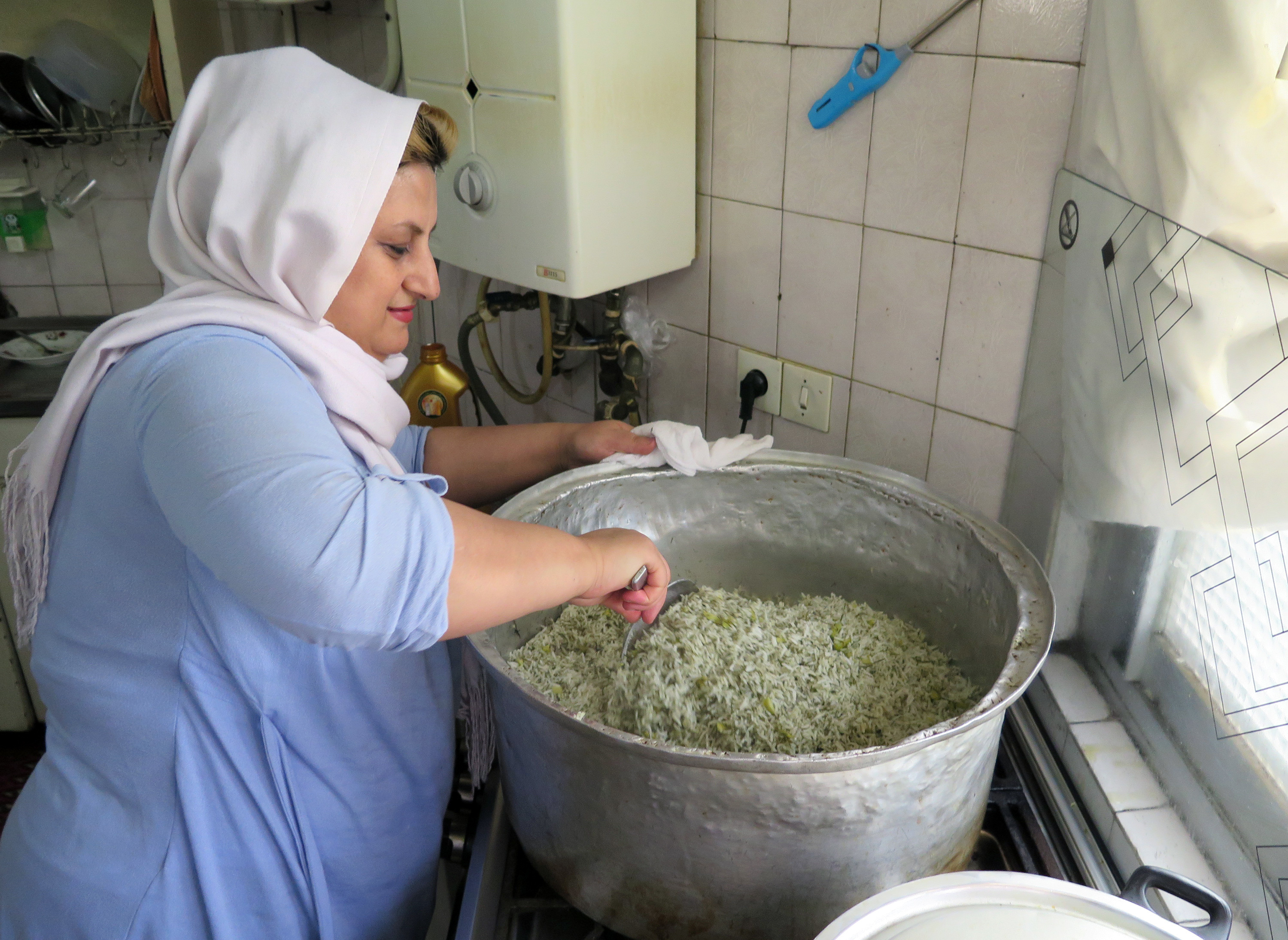 Maral Mohamedzadeh prepares food at her home for Mamanpaz, an organization that works with dozens of housewives to deliver home-cooked meals to businesses.
(Kevin Leahy/NPR)