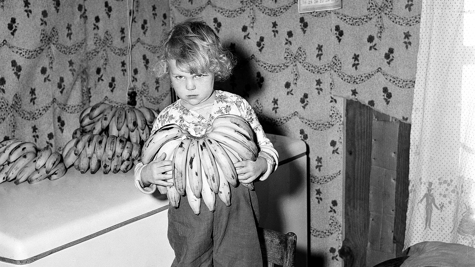 Susan Morgan, age 5, holds a bunch of bananas in Ponchatoula, La., in 1955. Susan was diagnosed with celiac disease and was prescribed a diet of 200 bananas weekly.