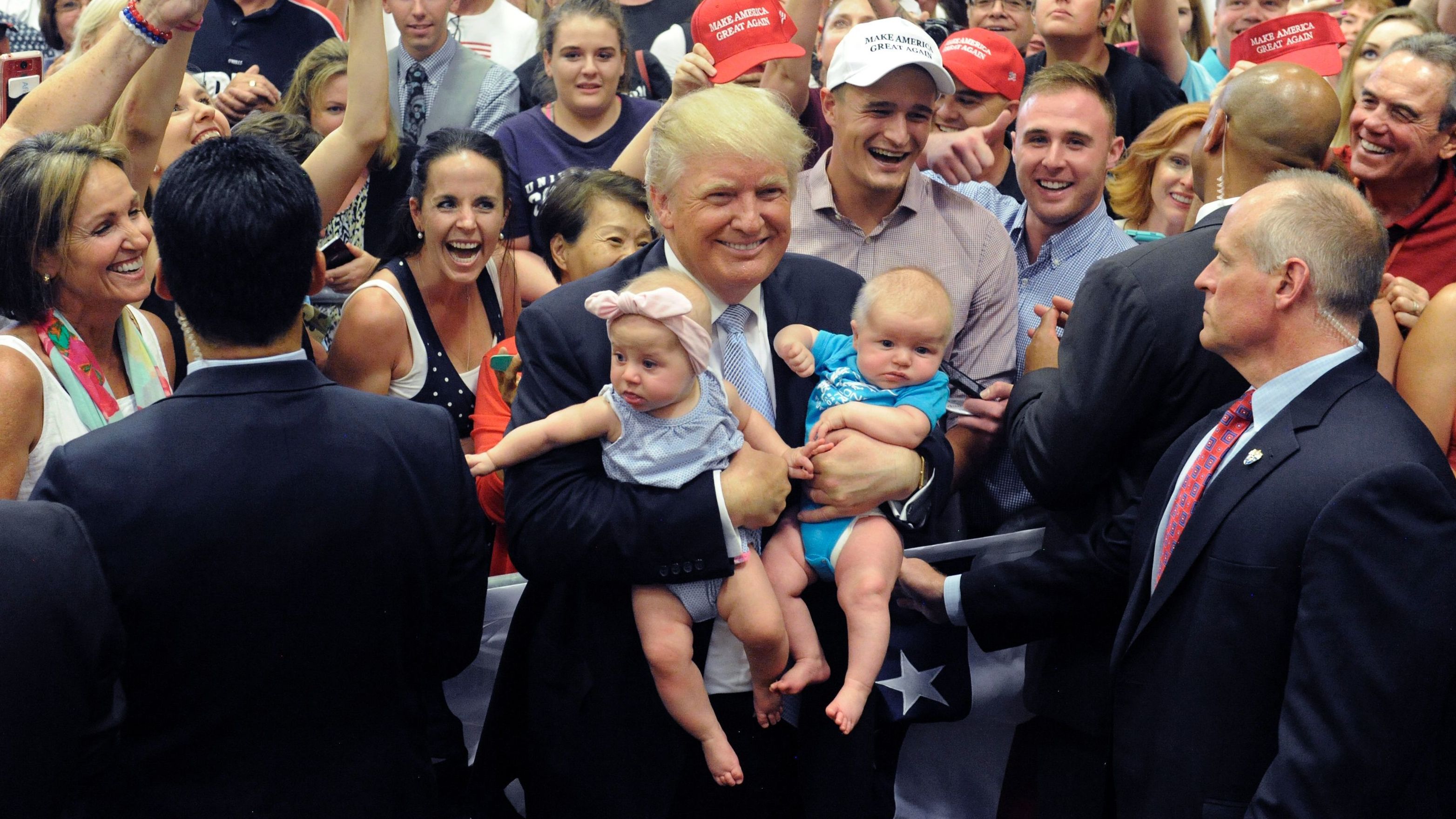 Then-candidate Donald Trump holds two babies after his Town Hall address at the Gallogly Events Center in Colorado Springs, Colo., last July. (AFP/Getty Images)