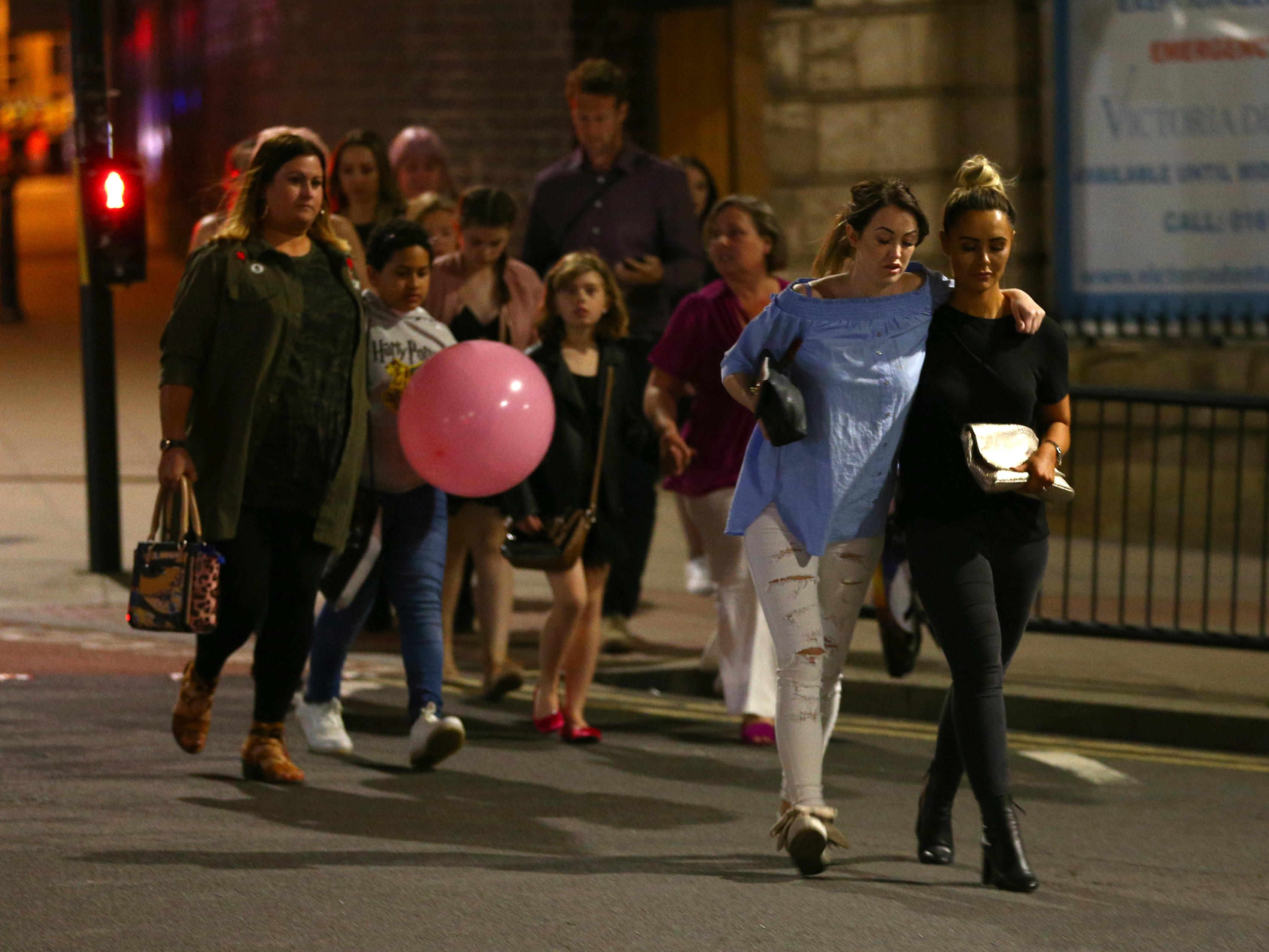 People leave Manchester Arena in England on Monday night following an explosion that killed at least 22 victims and wounded dozens more.
(Dave Thompson/Getty Images)