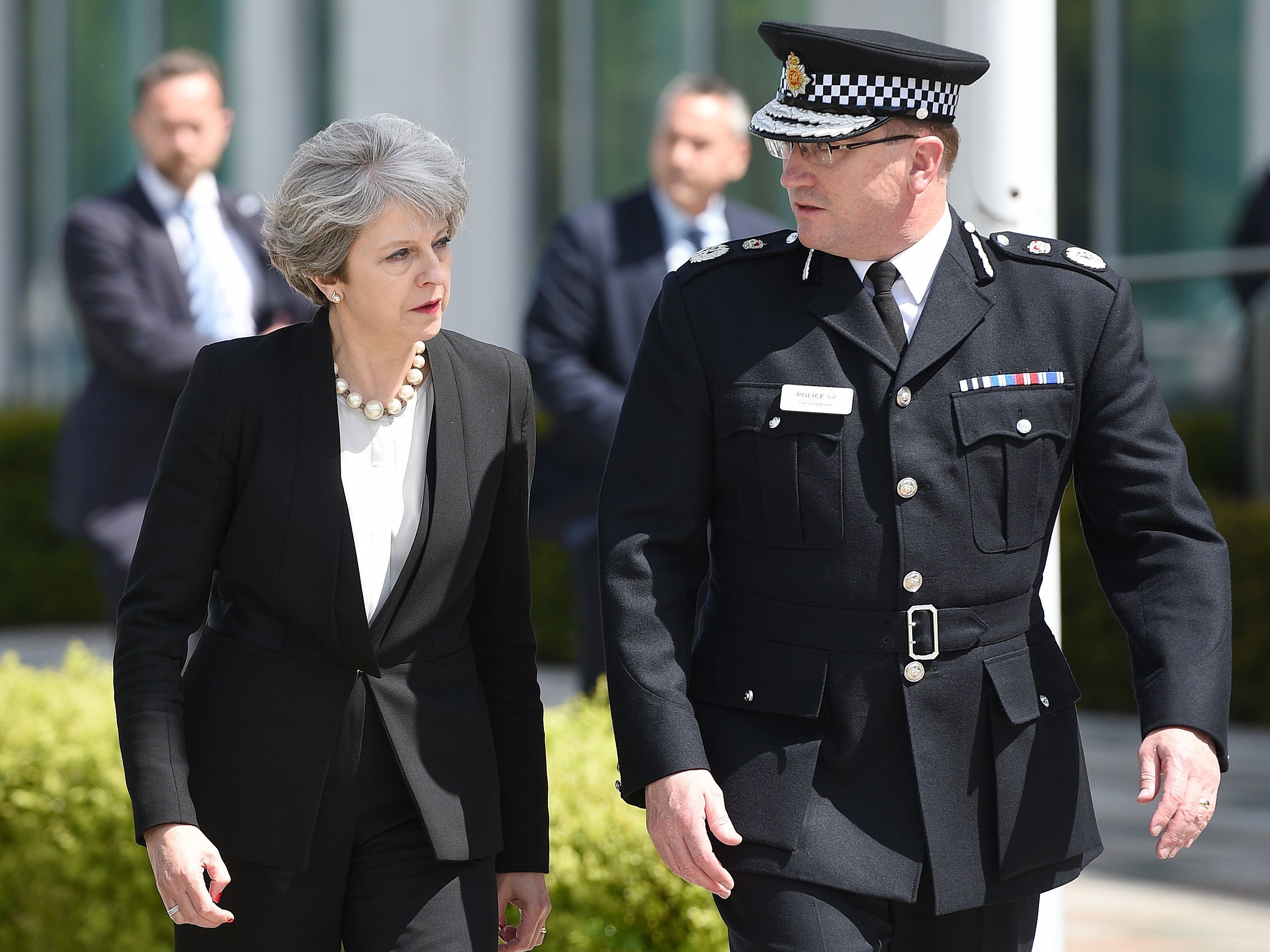 Britain's Prime Minister Theresa May walks with Chief Constable of Greater Manchester Police Ian Hopkins as she arrives at the force's headquarters in Manchester on Tuesday following a deadly terrorist attack the night before. (Oli Scarff/AFP/Getty Images)