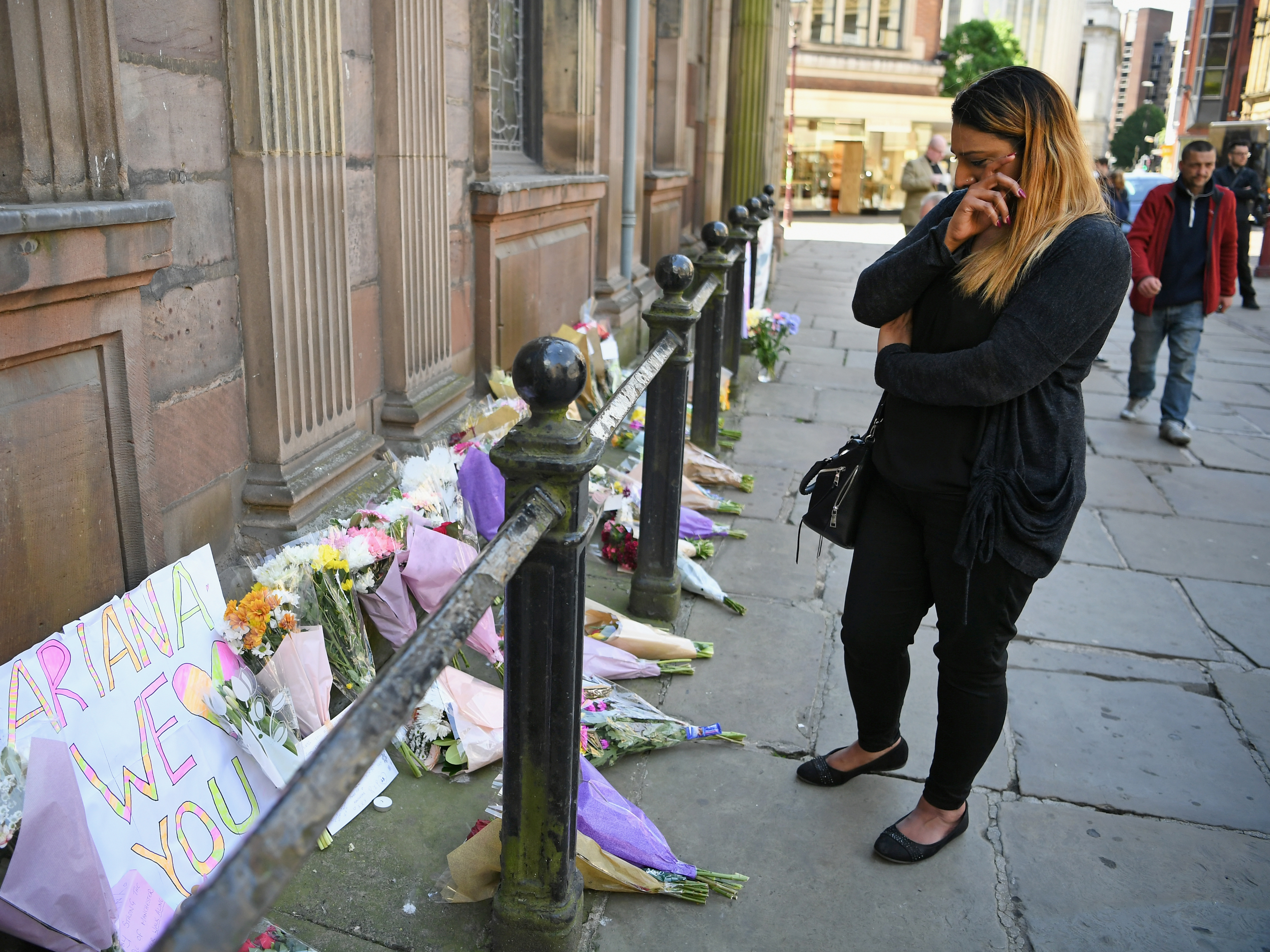 A woman looks at flowers left in Manchester's St. Ann Square on Tuesday, one day after a bomber carried out an attack at the end of an Ariana Grande concert in the city.
(Jeff Mitchell/Getty Images)