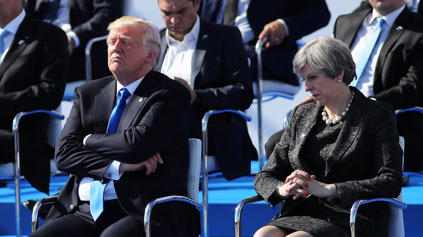 President Donald Trump and British Prime Minister Theresa May await a photo opportunity at a NATO summit meeting in Brussels on Thursday.