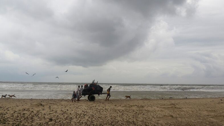 Bangladeshi villagers evacuate to cyclone shelters in Cox's Bazar district on Tuesday, as more than 350,000 people fled coastal villages to avoid Cyclone Mora. (AFP/Getty Images)