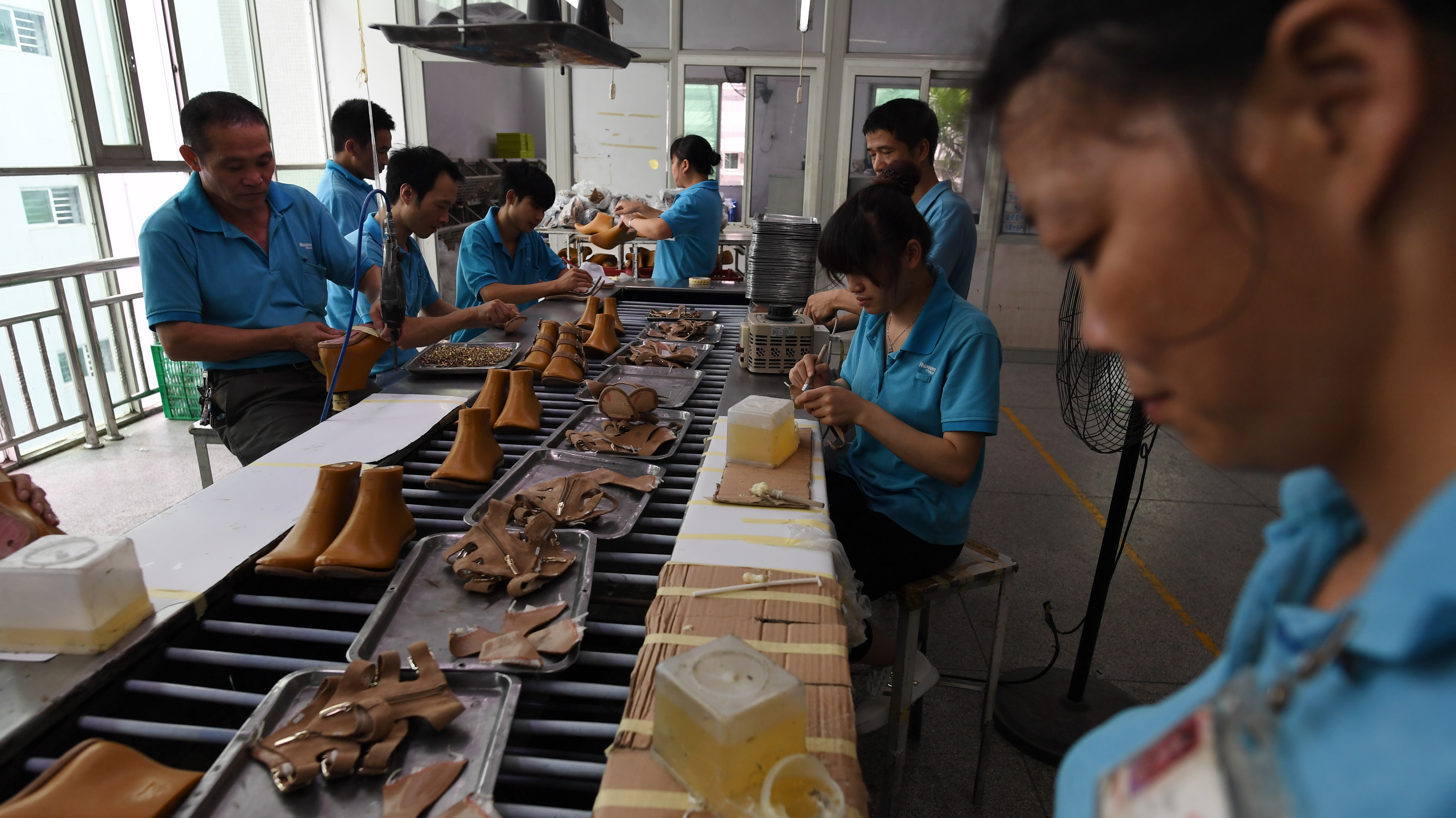 Workers assemble shoes in 2016 at a Huajian shoe factory in southern China, where about 100,000 pairs of Ivanka Trump-branded shoes have been made over the years. (AFP/Getty Images)