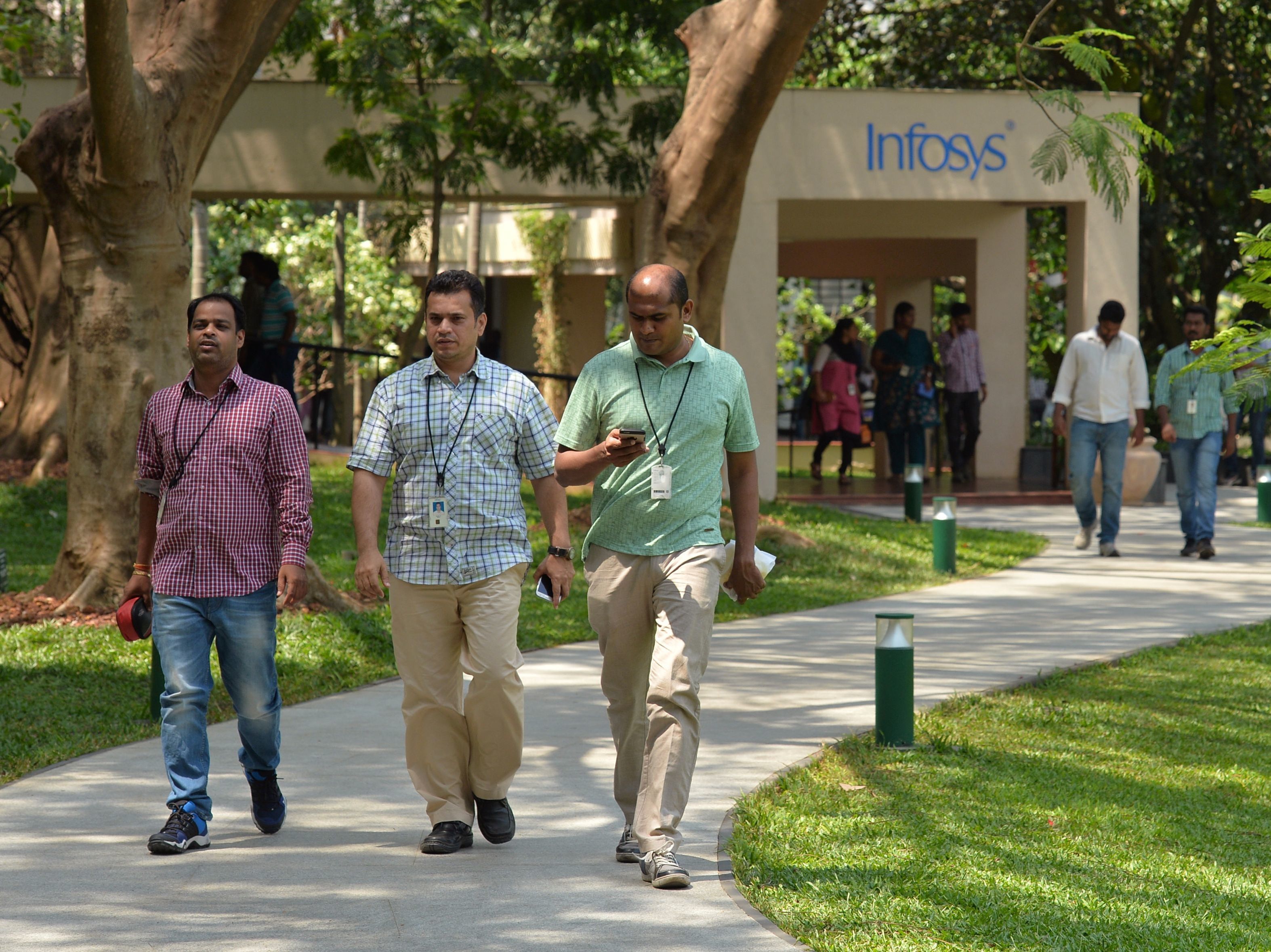 Employees of Infosys Technologies walk on the campus of the company's headquarters in Bangalore, India, on April 13. (Manjunath Kiran/AFP/Getty Images)