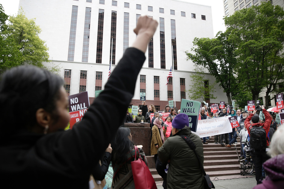 Protesters gather outside the 9th U.S. Circuit Court of Appeals in Seattle last month as judges prepare to hear arguments on the revised travel ban. This week, the Justice Department took its challenge to blocks on the ban to the U.S. Supreme Court. (Jason Redmond/AFP/Getty Images)