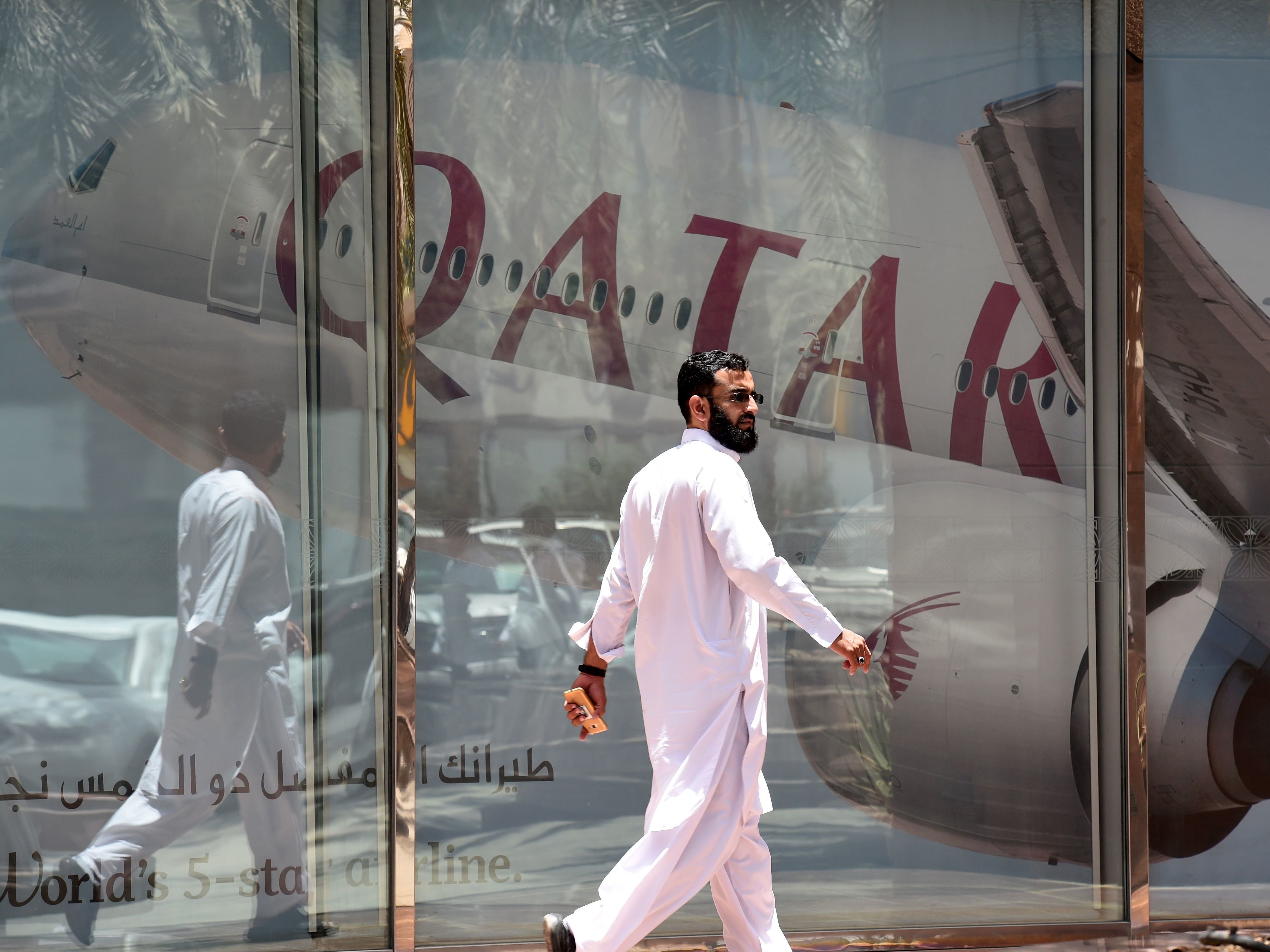 A man walks past the Qatar Airways branch in the Saudi capital, Riyadh, on Monday. Saudi Arabia and other Gulf states severed relations with Qatar and restricted Qatari planes' use of their airspace. (AFP/Getty Images)