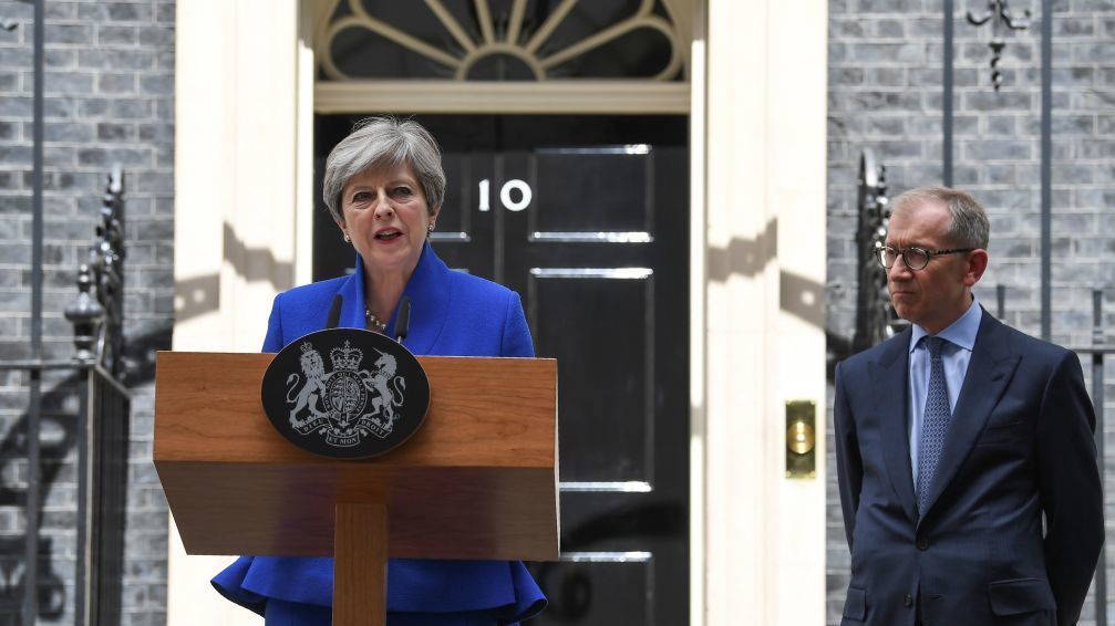 British Prime Minister and leader of the Conservative Party Theresa May, accompanied by her husband Philip, speaks outside No. 10 Downing St. in central London on Friday. (AFP/Getty Images)
