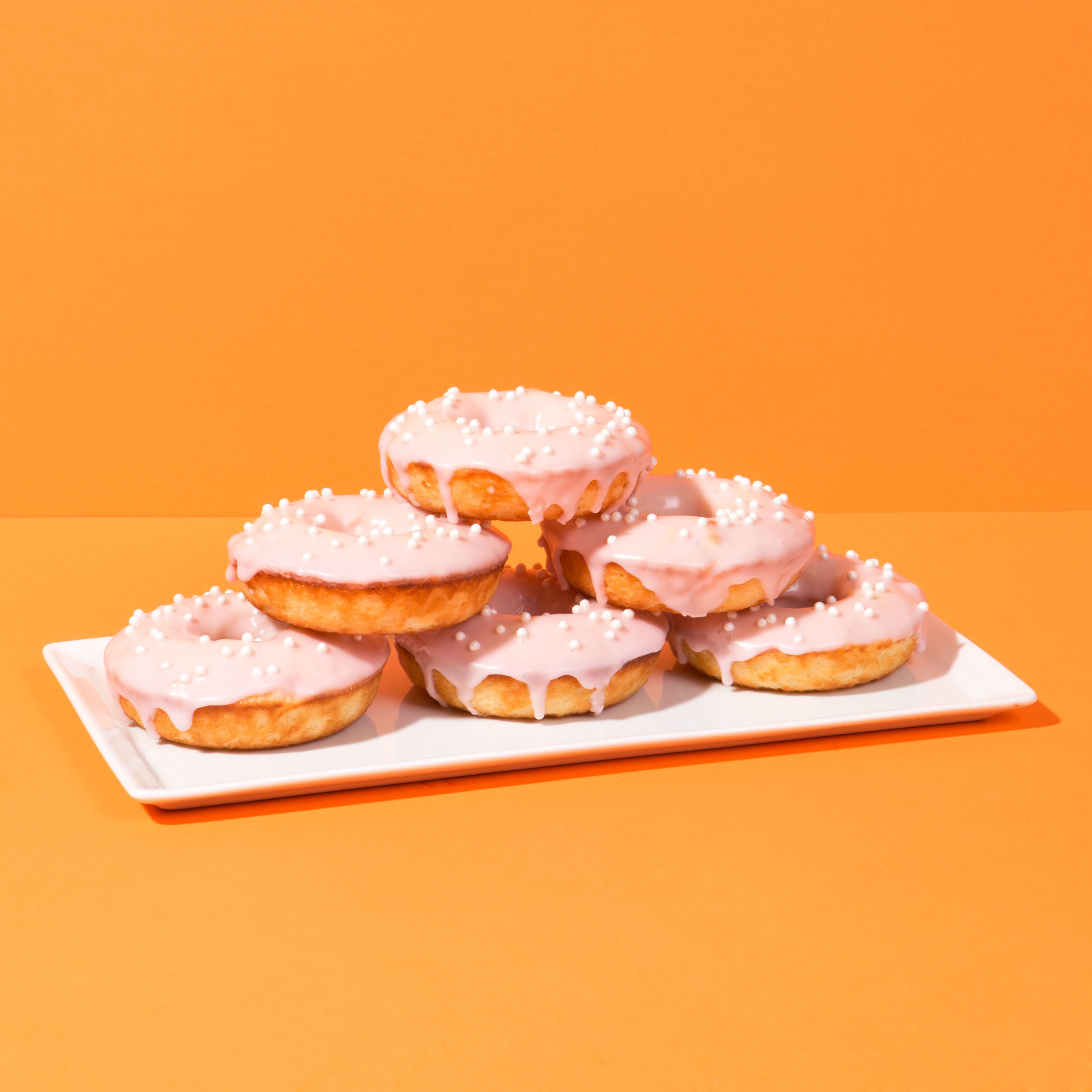 Baked crema Mexicana doughnuts with a blood orange glaze, as featured in the food blog Chicano Eats. On his bilingual blog, Esteban Castillo shares traditional and fusion Mexican recipes. The blog has a stunning, minimalist aesthetic meant to challenge the way people see Mexican food. (Esteban Castillo)