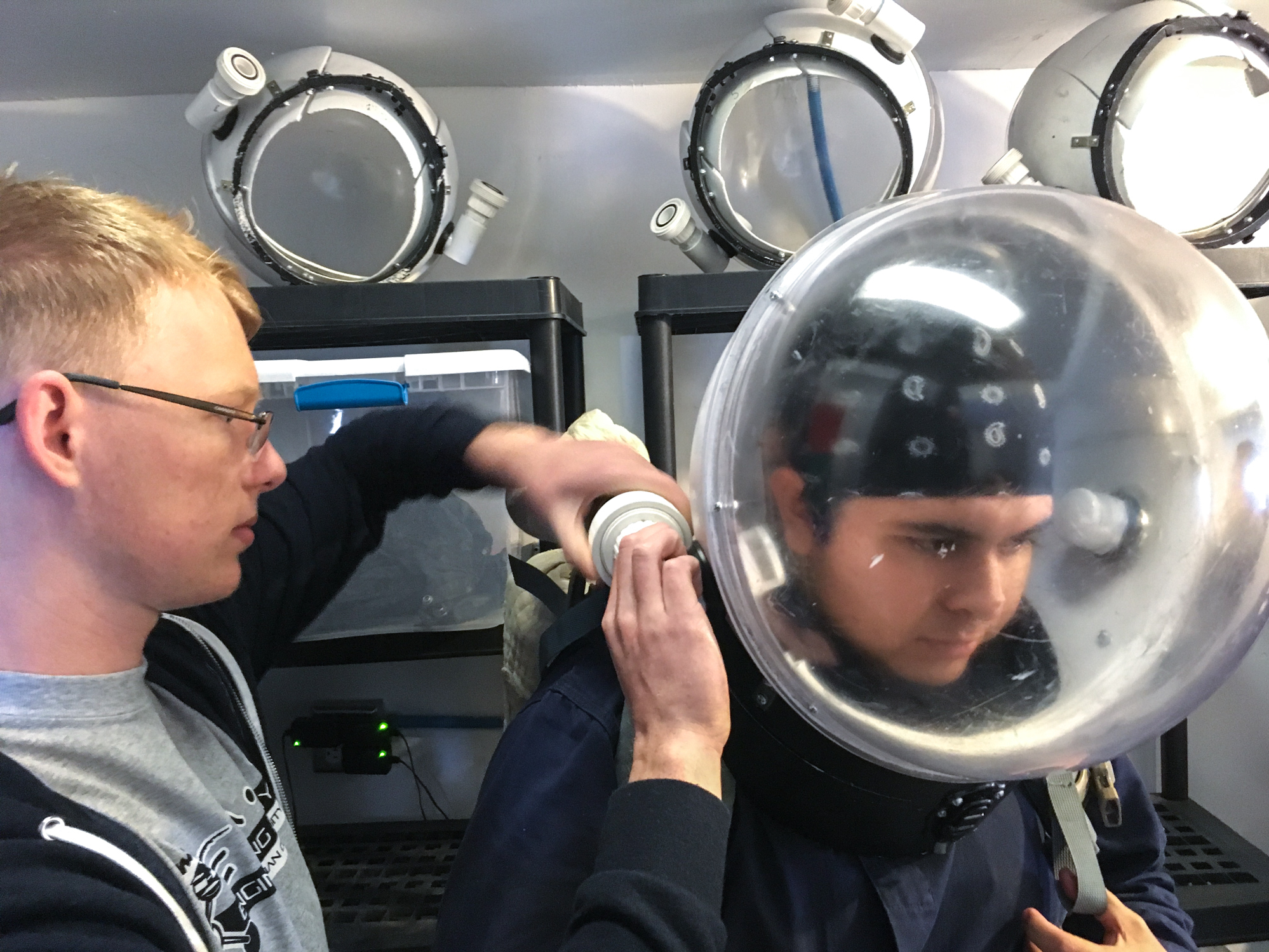 To Prepare For Mars Settlement, Simulated Missions Explore Utah's Desert 5 Quaas helps Espinoza suit up for a trip outside the station.