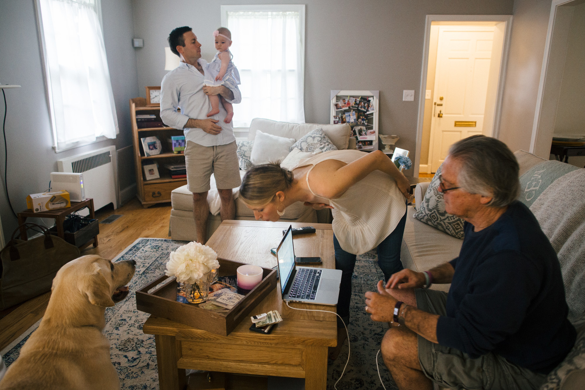 Greg sits with Colleen and Matt Everett and their daughter, Adeline. Greg has found his granddaughter brings new meaning to his life.