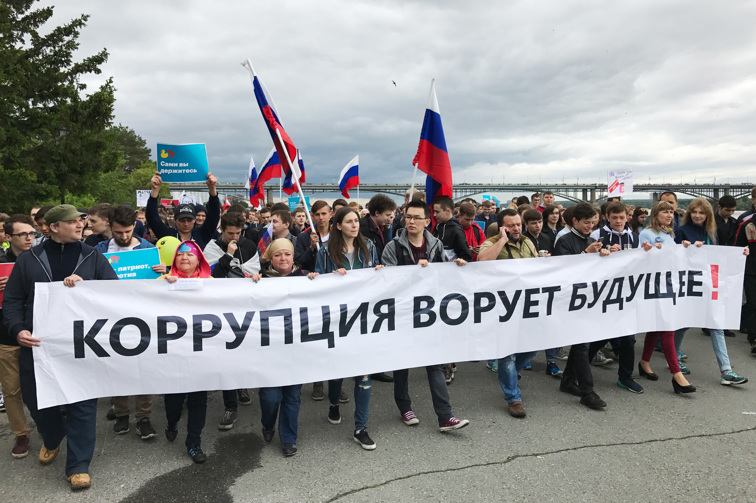 Anti-government protesters march in Novosibirsk, the capital of Siberia and Russia's third most populous city, with a banner reading &quot;Corruption steals the future!&quot; (NPR)