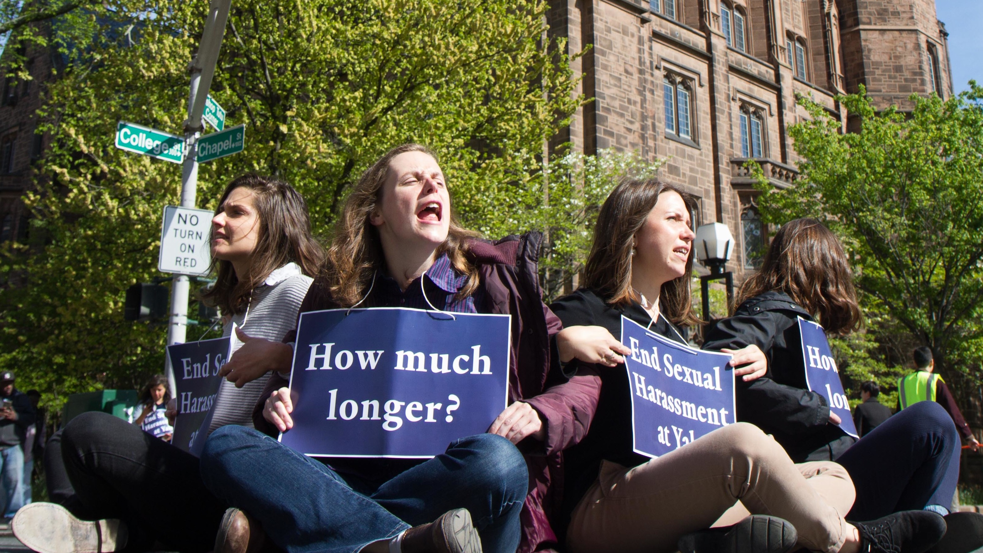 Yale graduate student instructors (from left) Kelly Goodman, Robin Canavan and Gwen Prowse block an intersection in downtown New Haven, Conn., on May 11, to protest what they say is the university's inaction on sexual harassment. (Local 33-Unite Here)