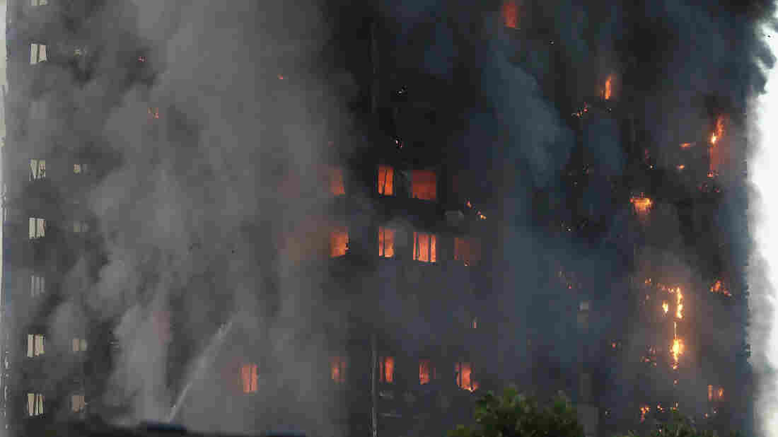 Smoke and flames rise from a building on fire in London on Wednesday.