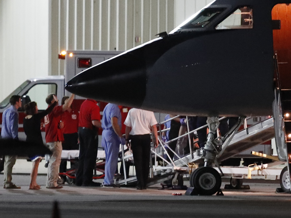 Otto Warmbier, a 22-year-old University of Virginia undergraduate who has been imprisoned in North Korea since January 2016, is transferred by medical personnel from a transport aircraft to an ambulance at Cincinnati Municipal Lunken Airport on Tuesday night. (John Minchillo/AP)