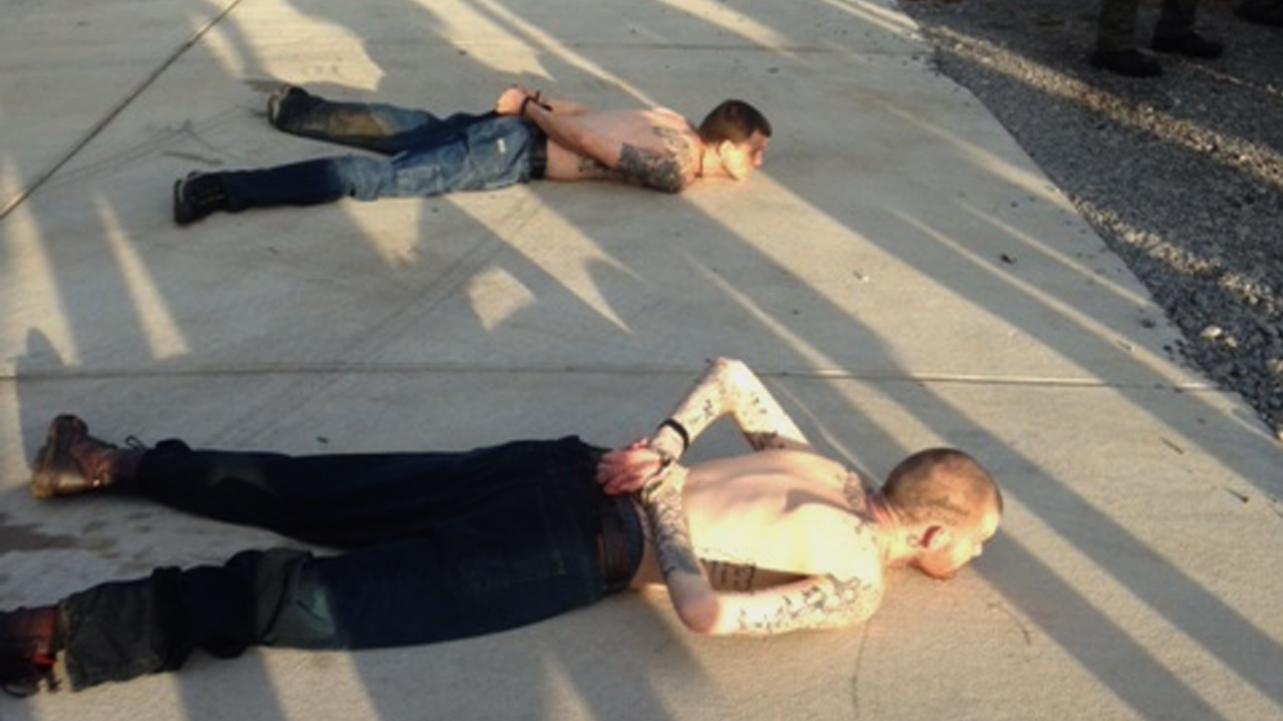 A Tennessee Bureau of Investigation photo shows the arrest of Georgia fugitives Donnie Rowe (top) and Ricky Dubose in Christiana, Tenn. The escaped inmates were captured Thursday in Tennessee after holding an elderly couple captive and leading police on a chase by car and foot, authorities said.