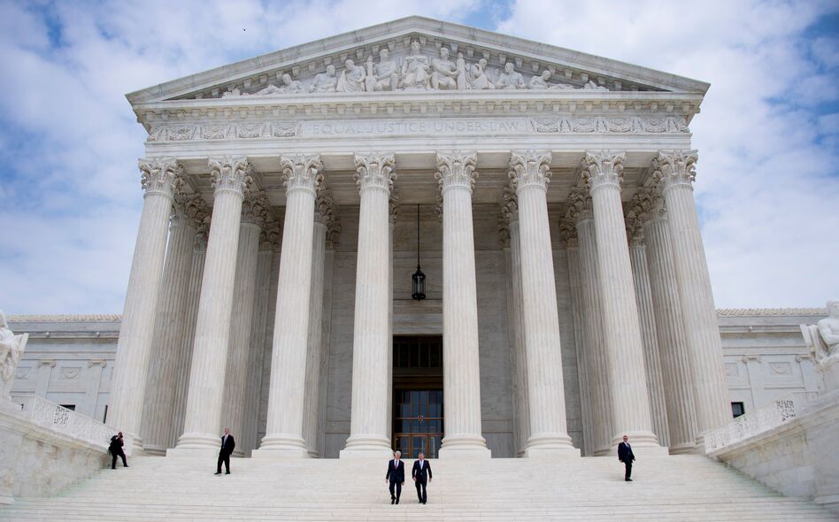 Chief Justice John Roberts (second from right) and Justice Neil Gorsuch (center) walk down the steps of the Supreme Court in Washington, D.C., last week. The court is wrapping up its term, with a handful of consequential cases decided on Monday. (Jim Watson/AFP/Getty Images)