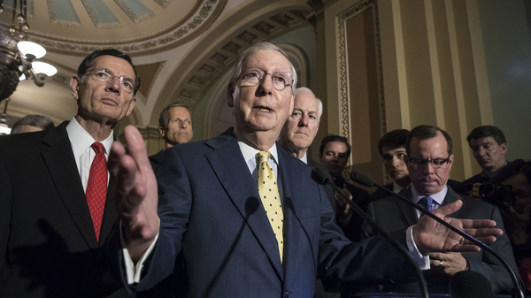 Senate Majority Leader Mitch McConnell, joined by other Republican senators, meets with reporters following a closed-door strategy session, at the Capitol on Tuesday.