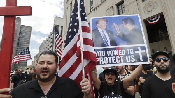 Iraqis and supporters rallied outside a Detroit courthouse Wednesday as a hearing began on a lawsuit that seeks to stop the government from deporting more than 100 Iraqi nationals who were recently rounded up.