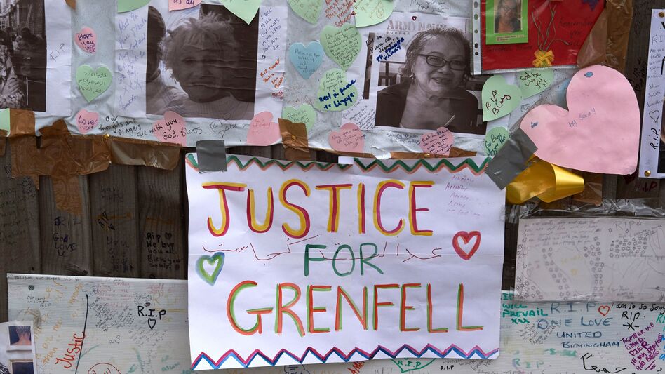 Tributes to victims of the Grenfell Tower fire are left near the building in West London on Friday. Combustible cladding has been found in a number of similar tower blocks in Britain, Prime Minister Theresa May said. (Niklas Halle'n/AFP/Getty Images)