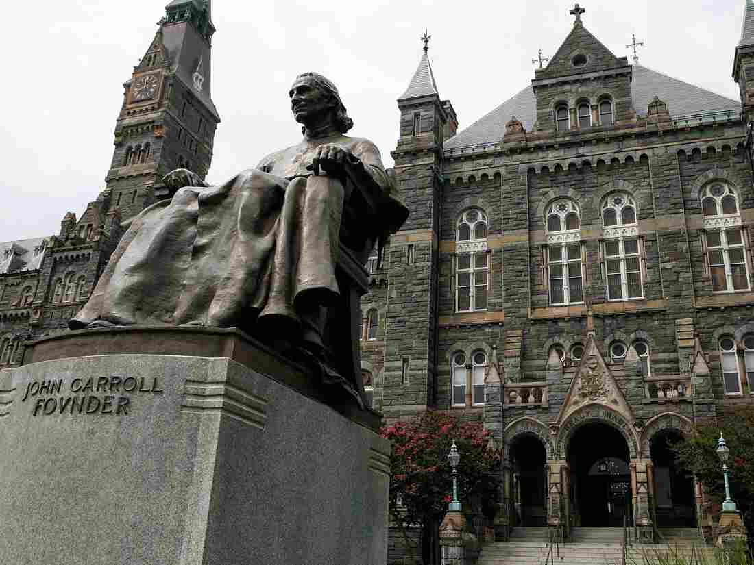 A statue of John Carroll, founder of Georgetown University, sits before Healy Hall on the school's campus. (Photo by Alex Wong/Getty Images)