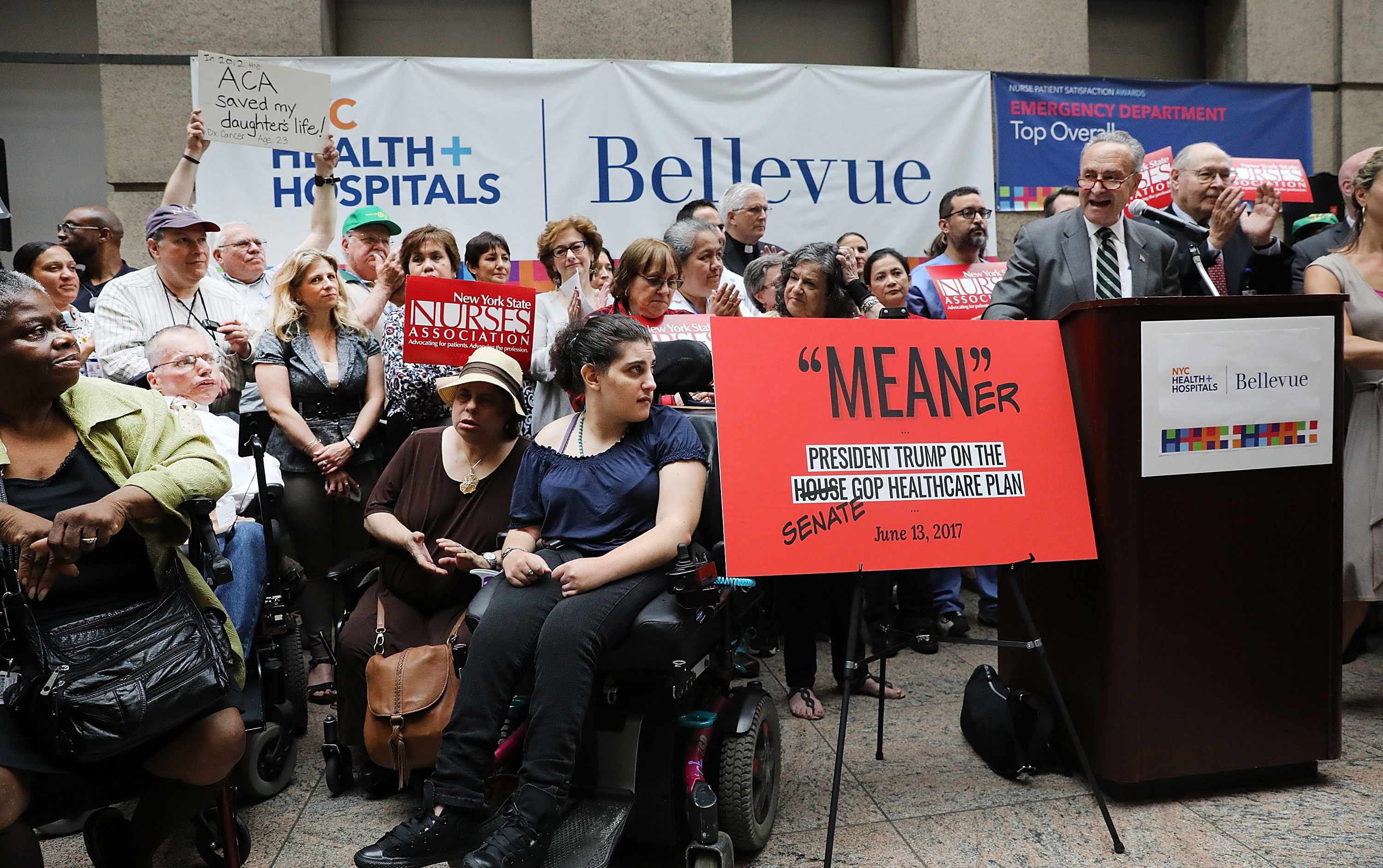 Doctors, nurses, patients and activists listen to Senate Minority Leader Chuck Schumer, D-N.Y., speak about Senate Republicans' health care bill on Friday at Bellevue Hospital in New York City. Schumer has vowed to help defeat the legislation, which the Congressional Budget Office scored on Monday. (Getty Images)