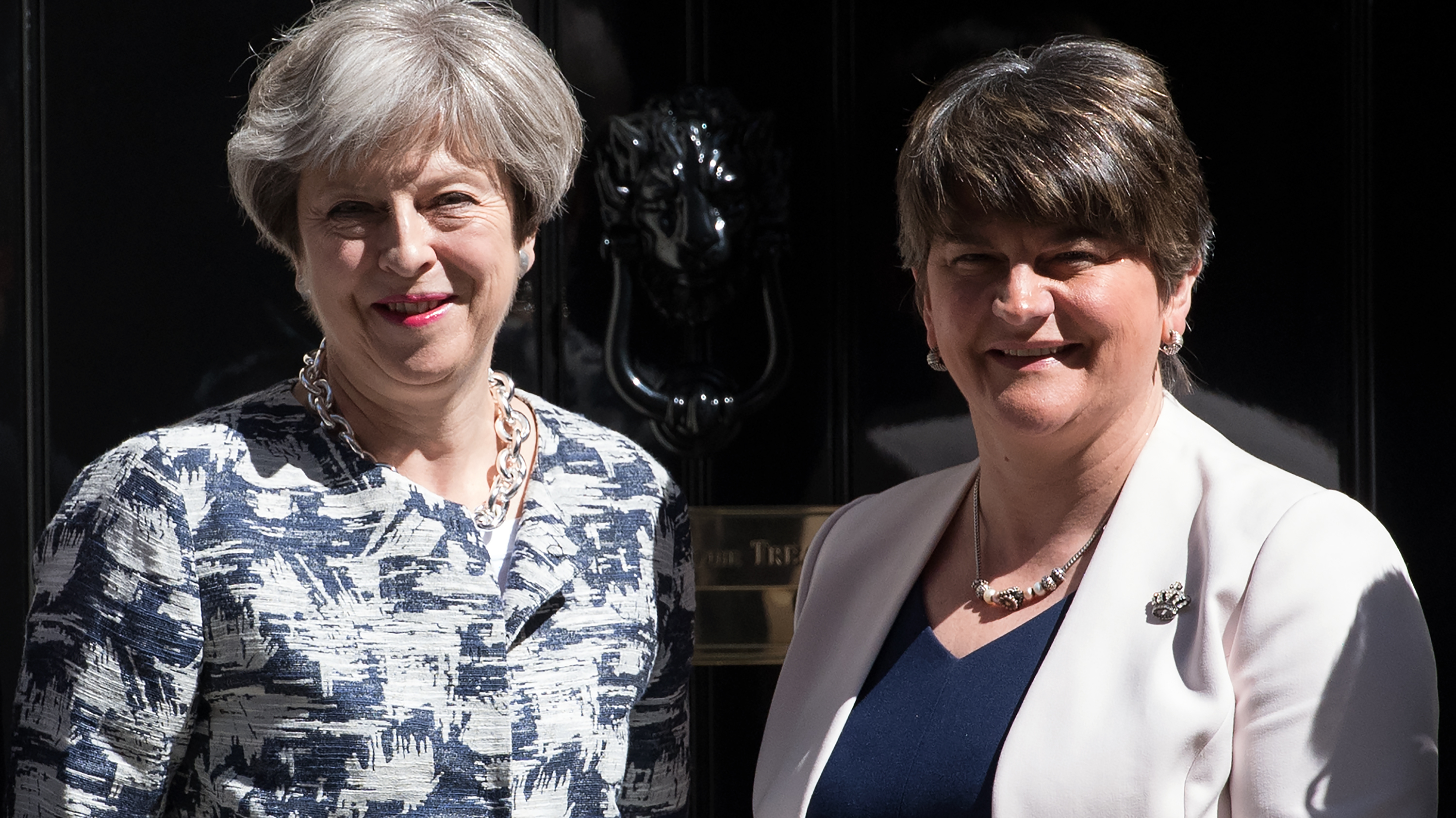 British Prime Minister Theresa May (left) greets Arlene Foster, leader of Northern Ireland's Democratic Unionist Party, outside 10 Downing St. in London on Monday. (Getty Images)