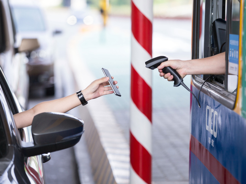 A driver uses his smartphone to pay the highway toll with Alipay, an app of Alibaba's online payment service, in the Chinese city of Hangzhou. (STR/AFP/Getty Images)