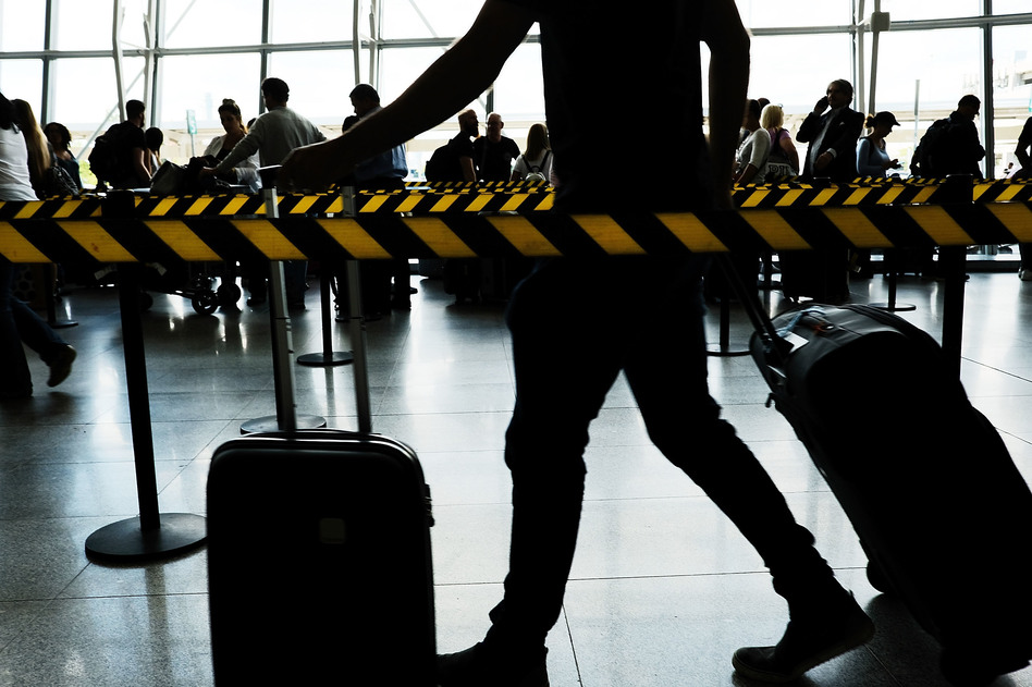 People arrive at John F. Kennedy international airport following an announcement by the Supreme Court that it will take President Donald Trump's travel ban case later in the year on Monday in New York City. (Spencer Platt/Getty Images)