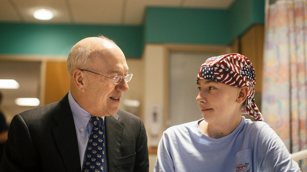 Dr. Kurt Newman visits with 14-year-old Jack Pessaud, who